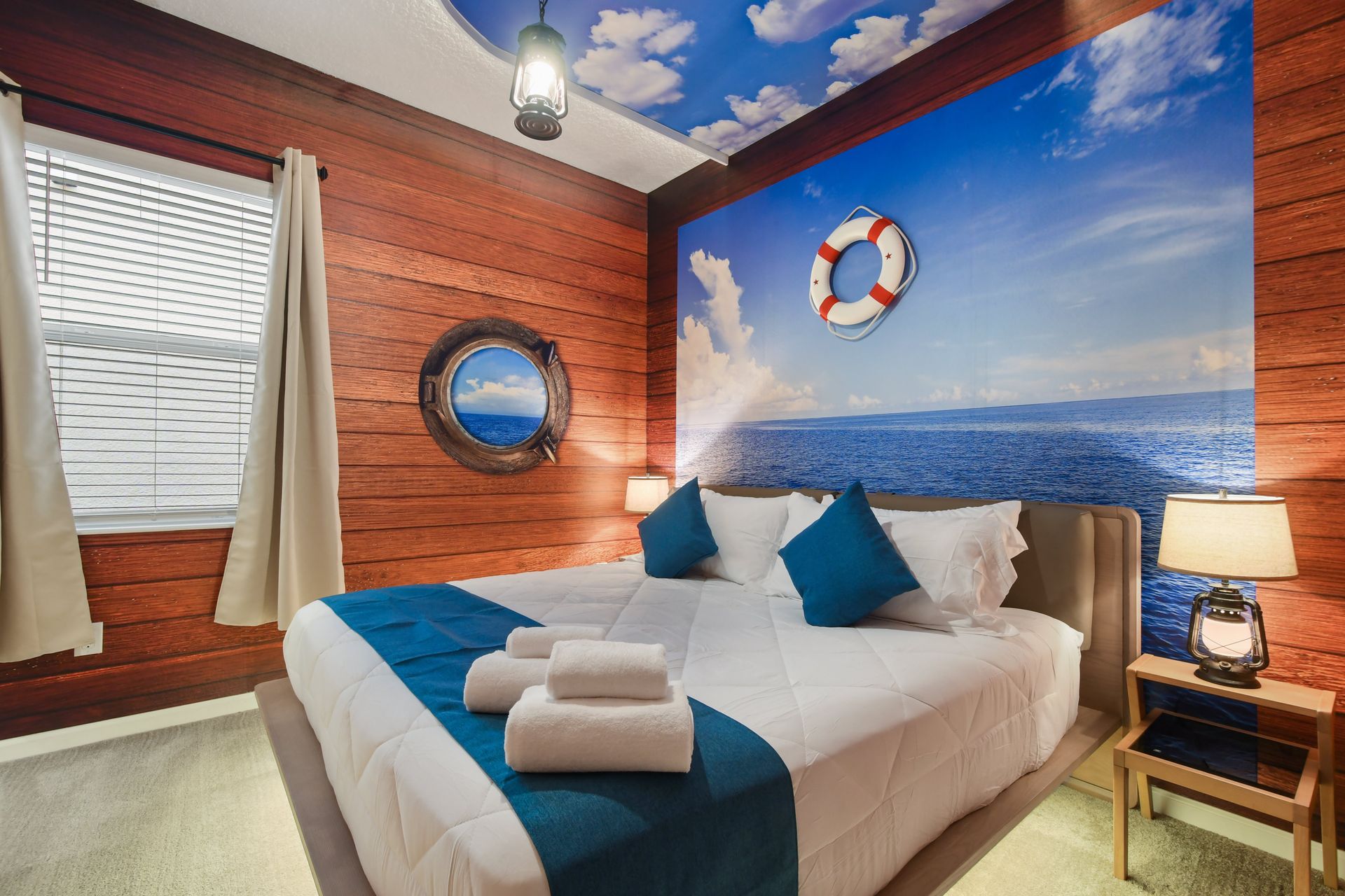 Nautical-themed bedroom with ocean views, wood accents, and cozy maritime decor.