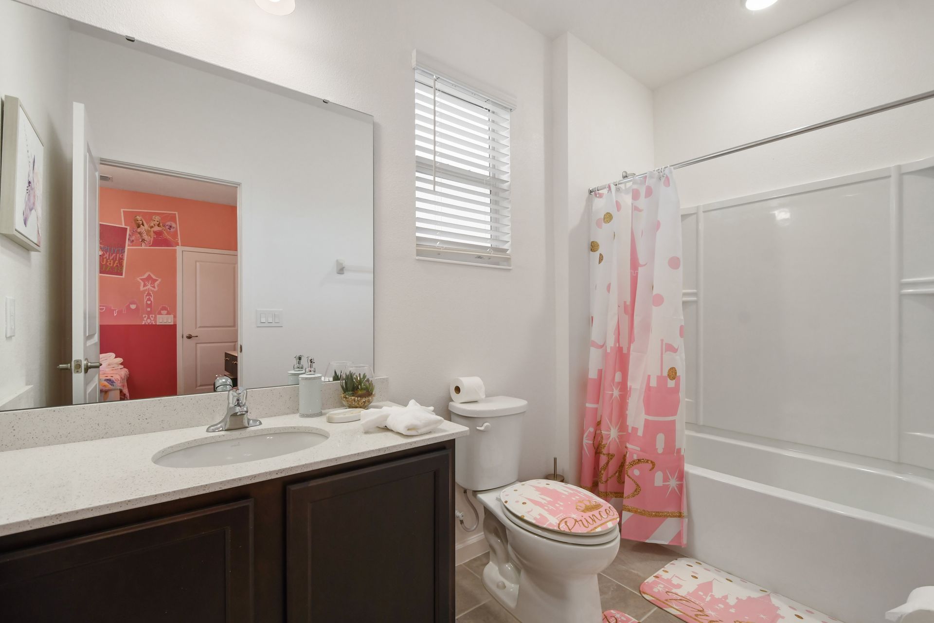 Bathroom with modern vanity, bright lighting, and a relaxing tub!