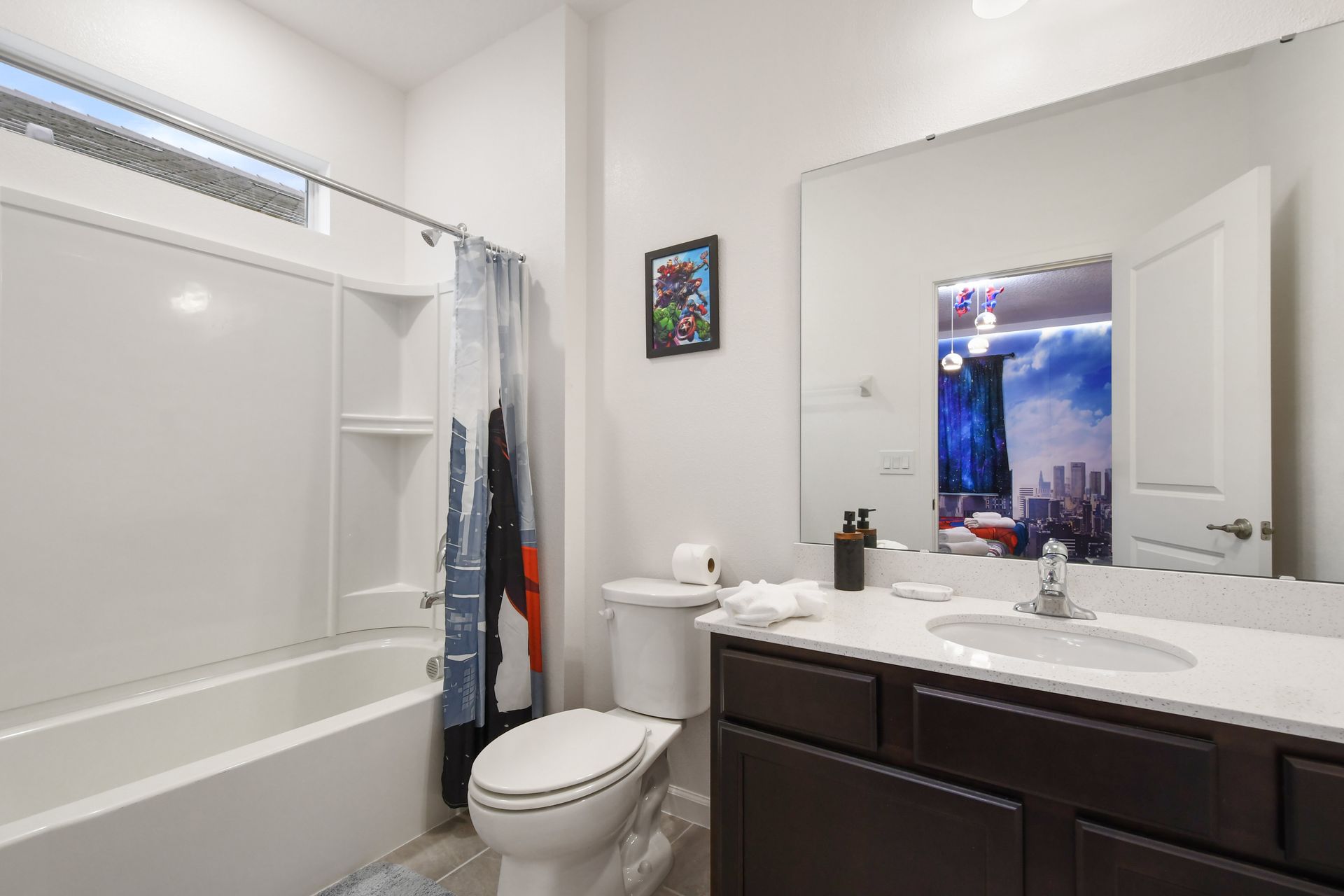 Bathroom with modern vanity, bright lighting, and a relaxing tub!