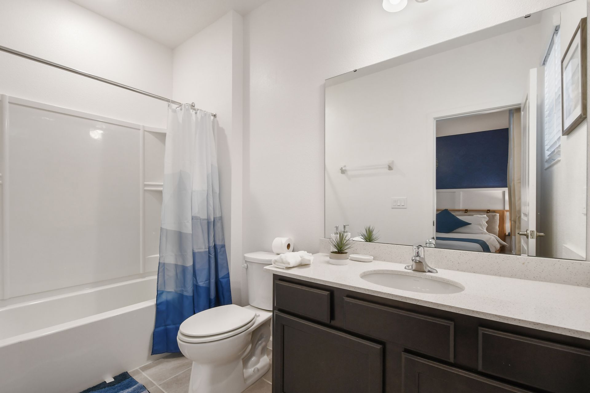 Bathroom with modern vanity, bright lighting, and a relaxing tub!