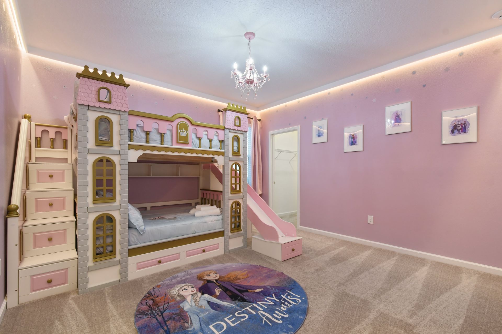 Magical princess-themed bedroom with a castle bunk bed, slide, and dreamy decor.