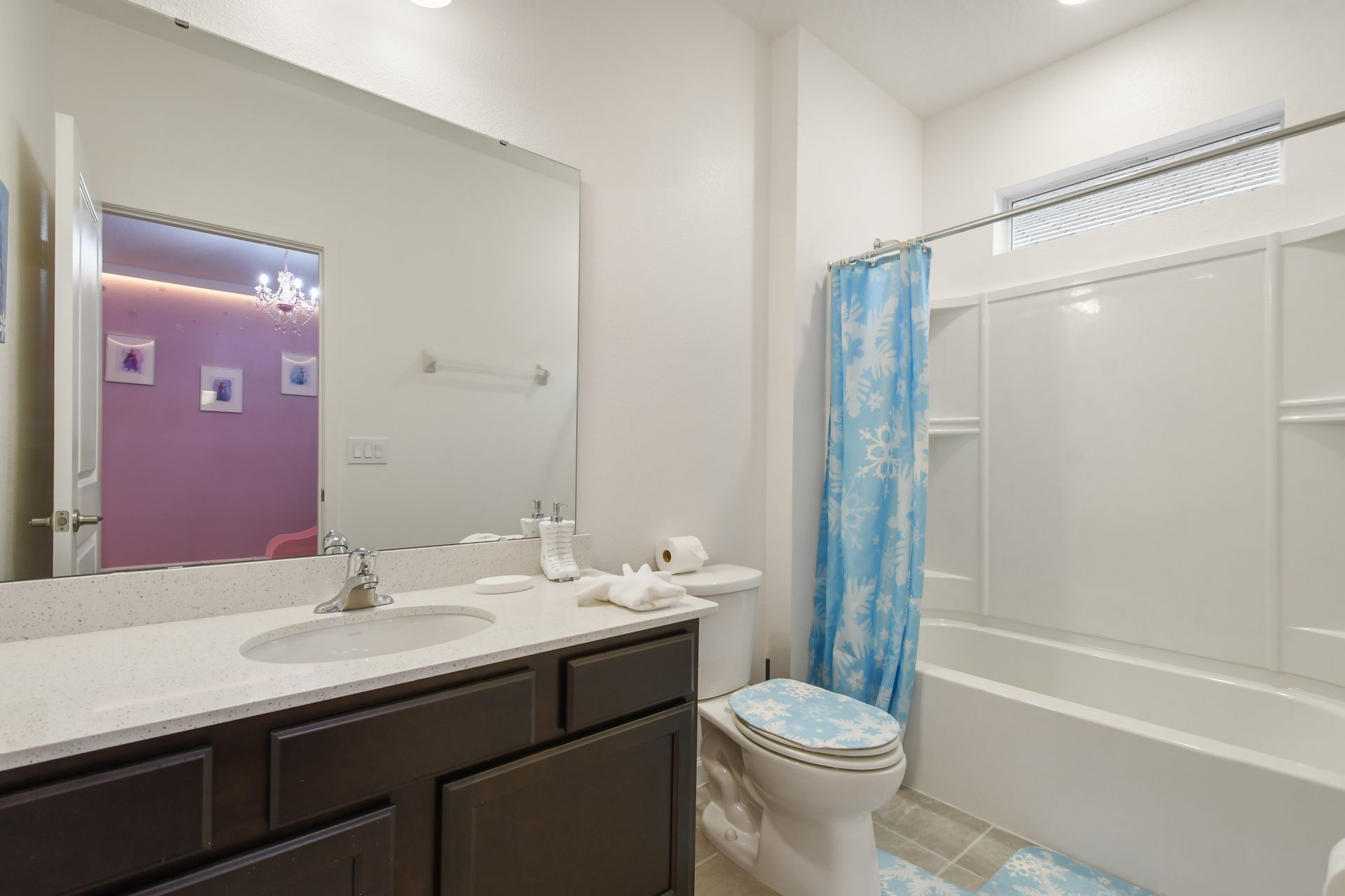 Bathroom with modern vanity, bright lighting, and a relaxing tub!