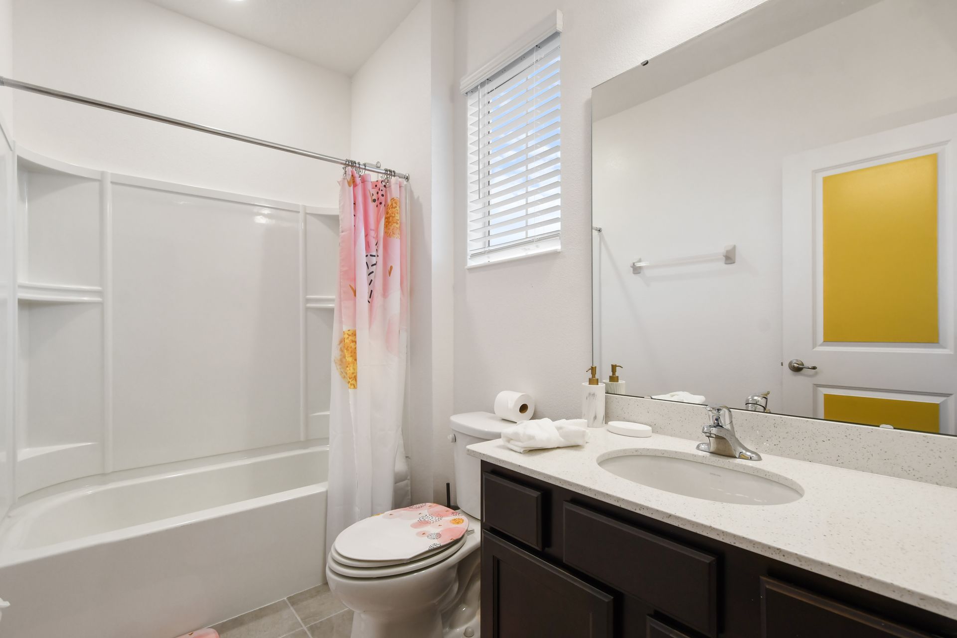 Bathroom with modern vanity, bright lighting, and a relaxing tub!
