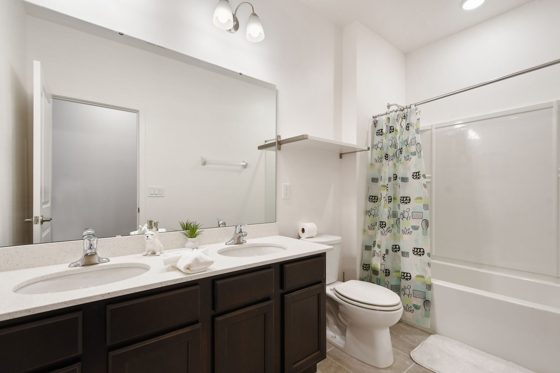 Bathroom with modern vanity, bright lighting, and a relaxing tub!
