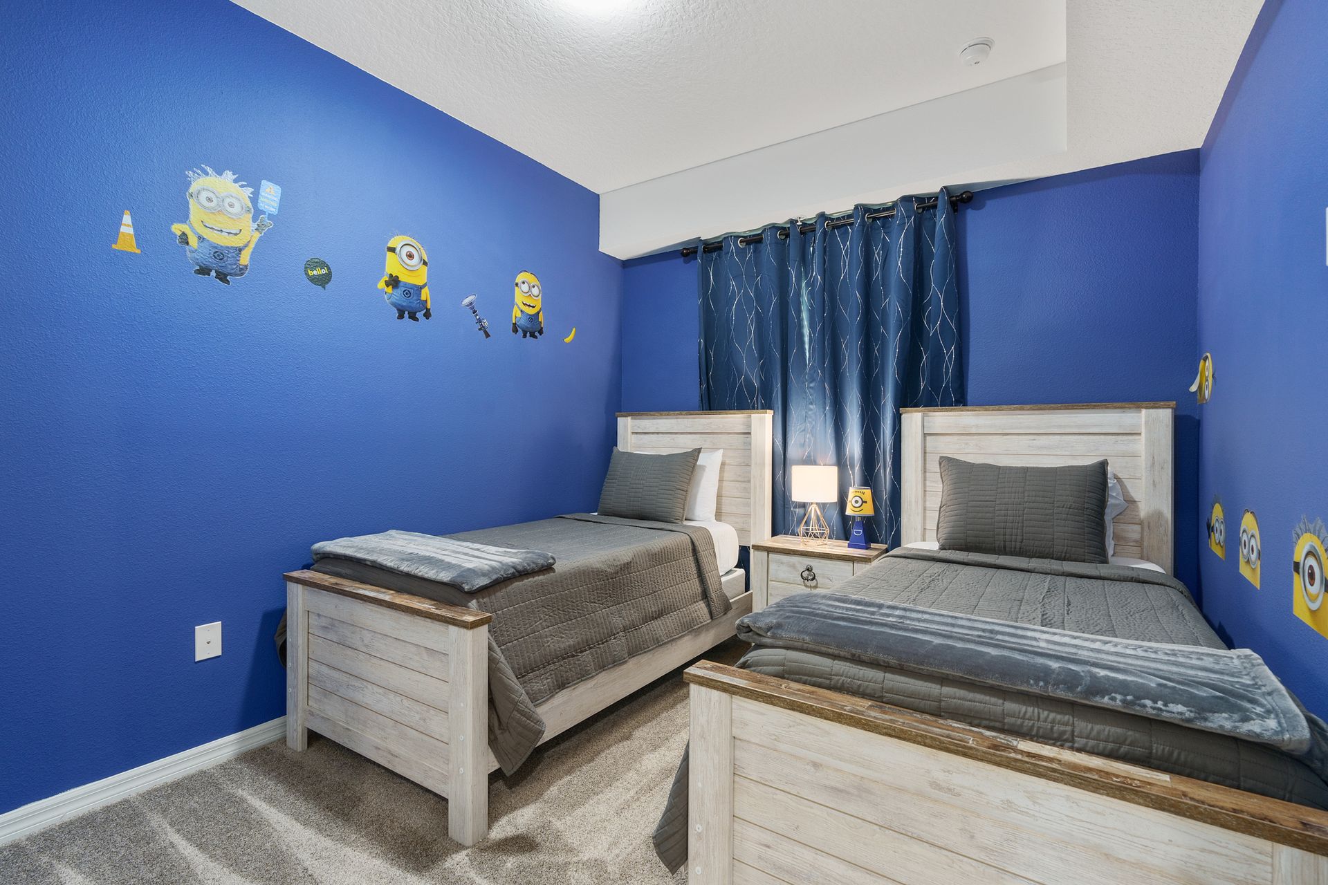 Bedroom adorned with a delightful Minion theme, featuring two single beds for a whimsical and playful ambiance