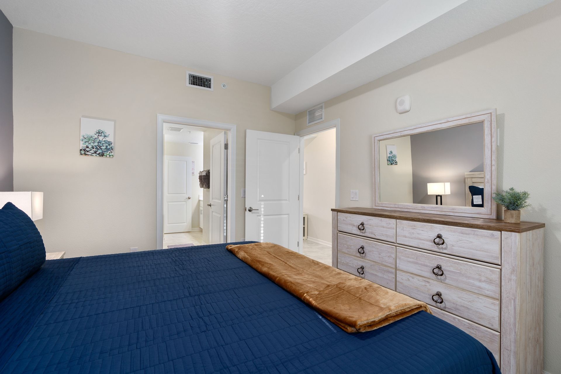 Inviting king-sized bedroom designed for coziness, offering a warm and comfortable space for a restful night's sleep