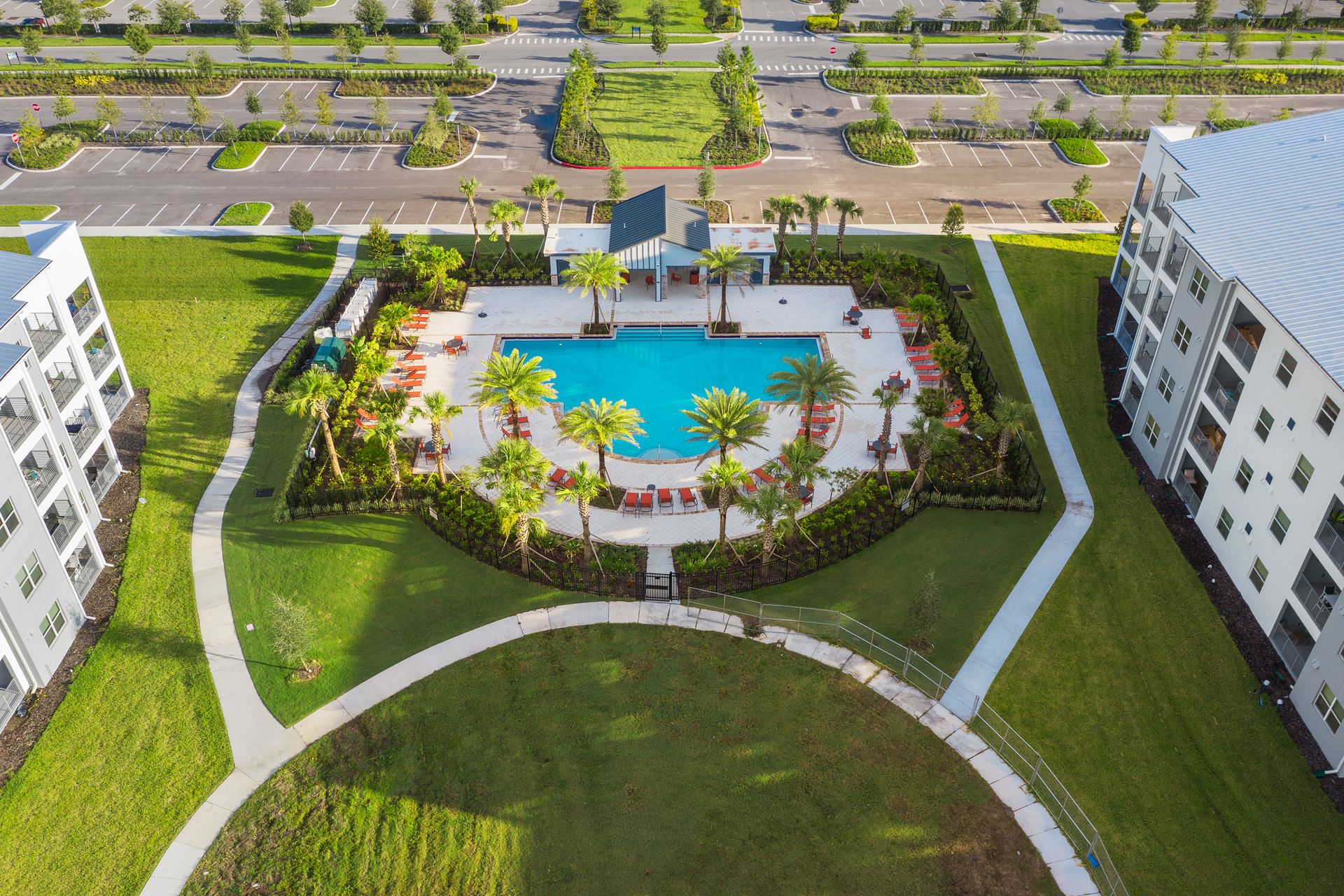 Resort Amenities -Resort Amenities - A stunning pool surrounded by swaying palm trees, creating a picturesque setting for guests to enjoy a refreshing and tranquil escape