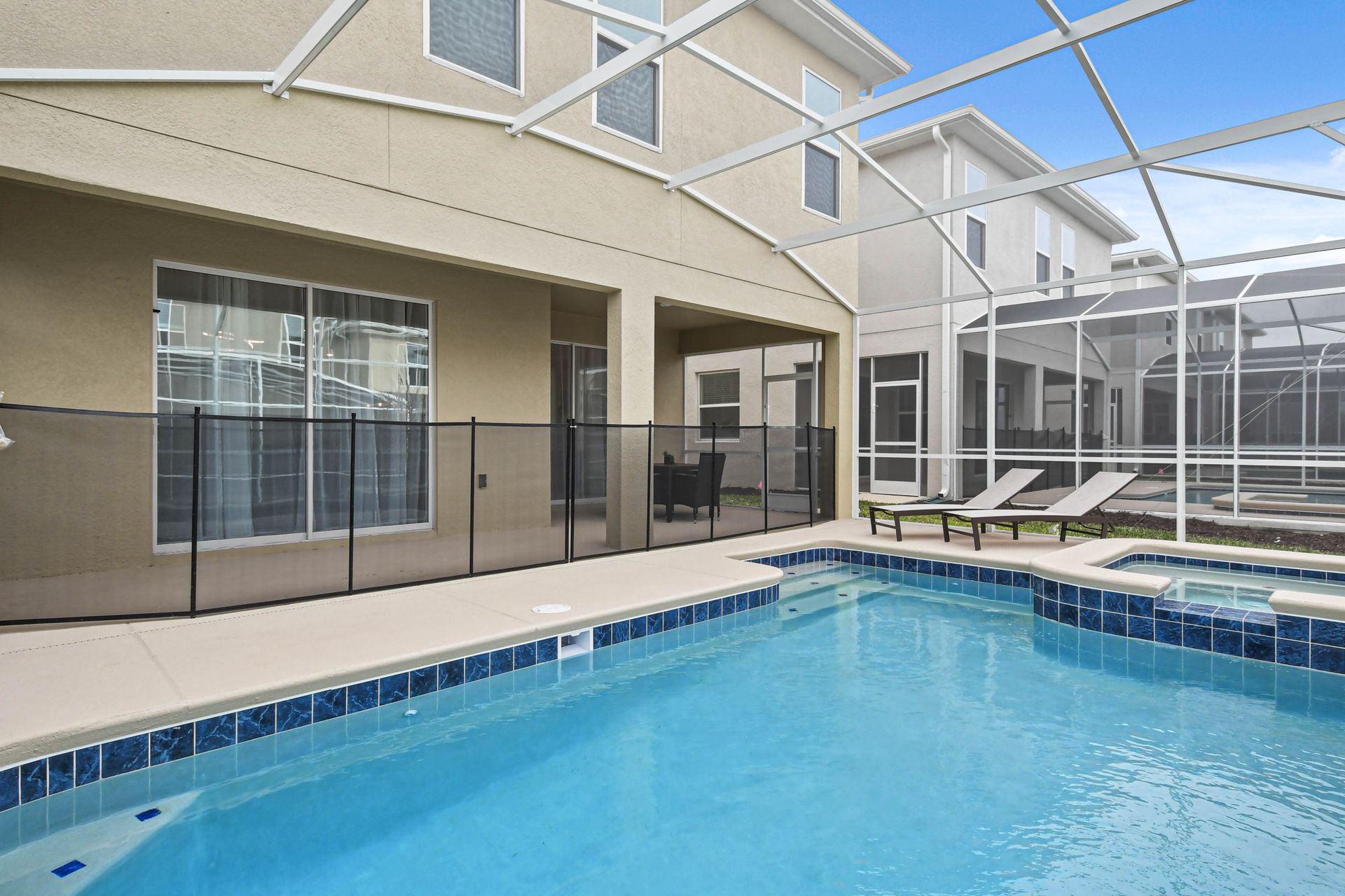 The outdoor pool area is a luxurious retreat for relaxation and entertainment. It features a large, heated swimming pool.