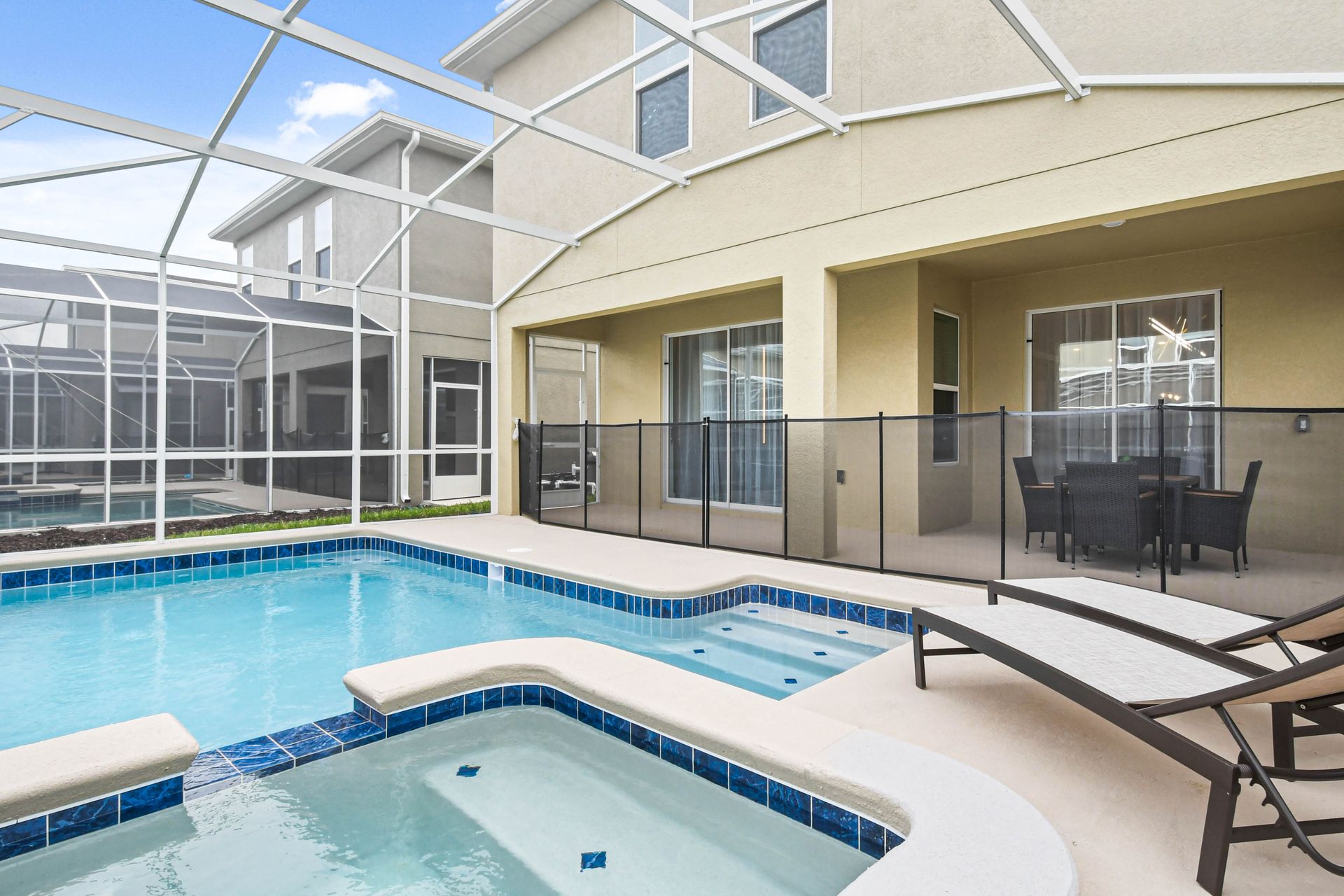 The outdoor pool area is a luxurious retreat for relaxation and entertainment. It features a large, heated swimming pool.