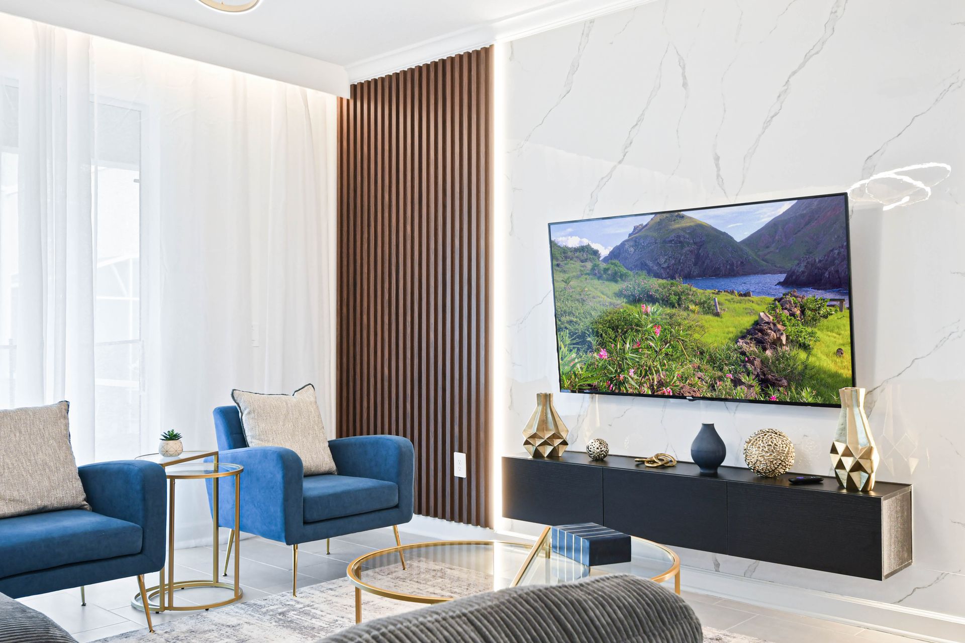 Elegant modern living room with sleek décor, plush seating, and a large smart TV.