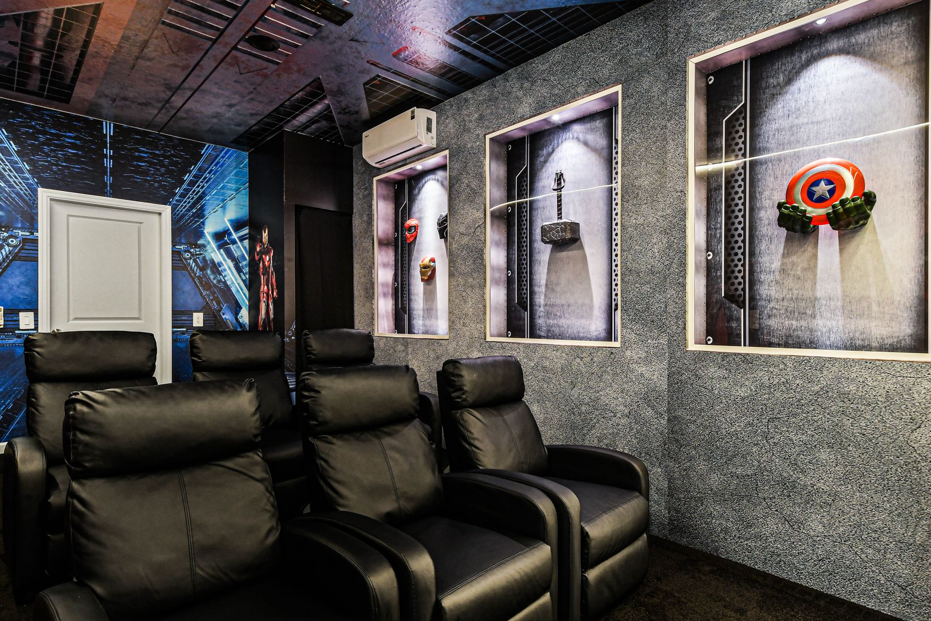 Marvel-themed home theater with luxe recliners, hero displays, and cinematic atmosphere.
