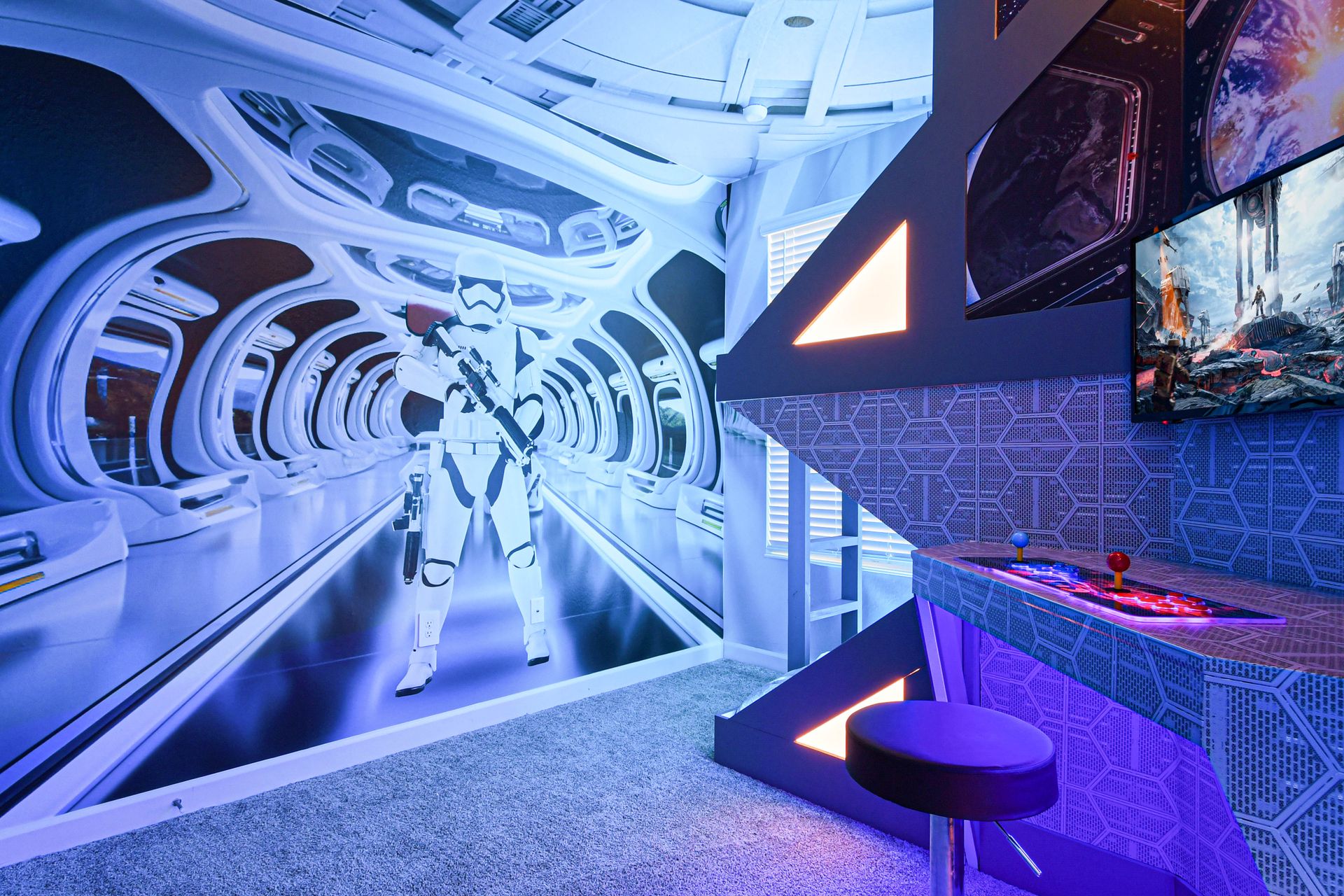 Futuristic space-themed arcade room with glowing lights, gaming setup, and epic décor.