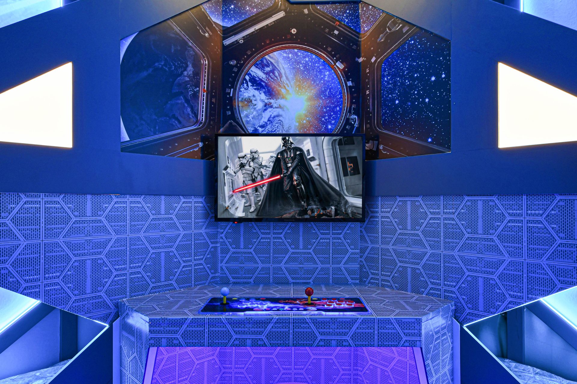 Immersive galactic-themed game room with glowing arcade setup and epic space vibes.