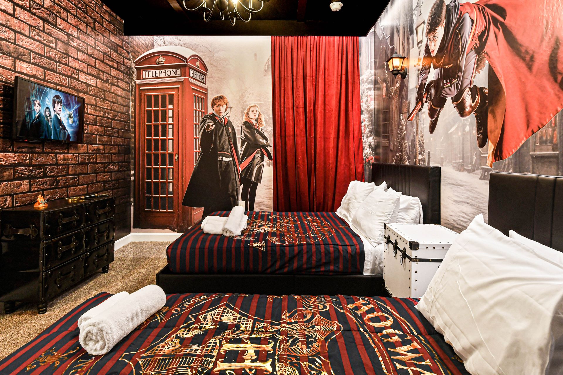 Wizarding world-themed bedroom with twin beds, magical murals, and enchanting décor.