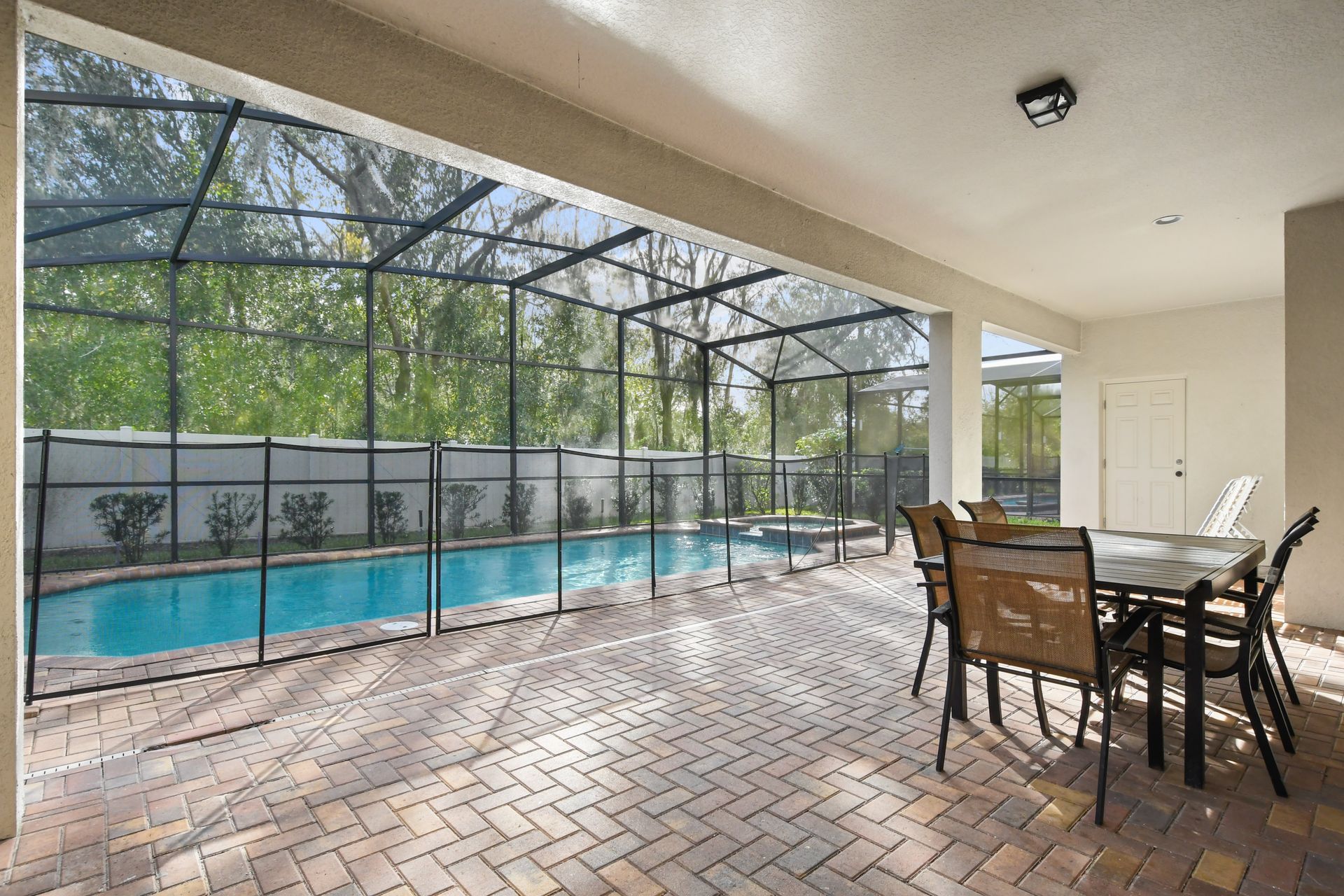 Dine poolside in this screened patio with spa, private views, and sunny charm.