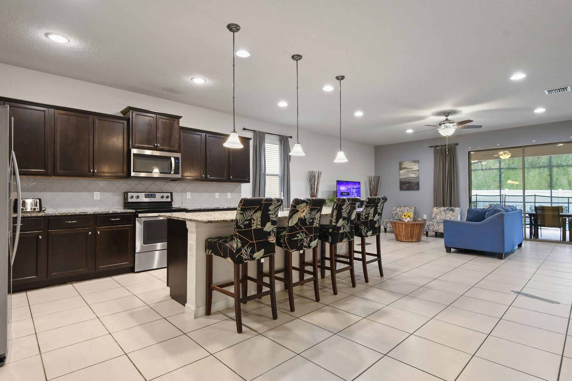 Stylish kitchen with island seating, stainless appliances, and open living views.