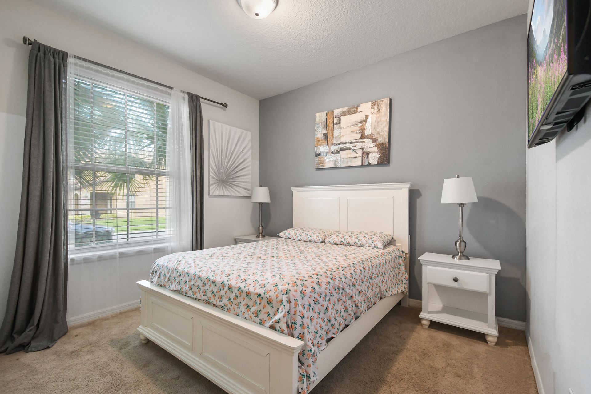 Charming bedroom with queen bed, floral touches, and a cozy, inviting feel.