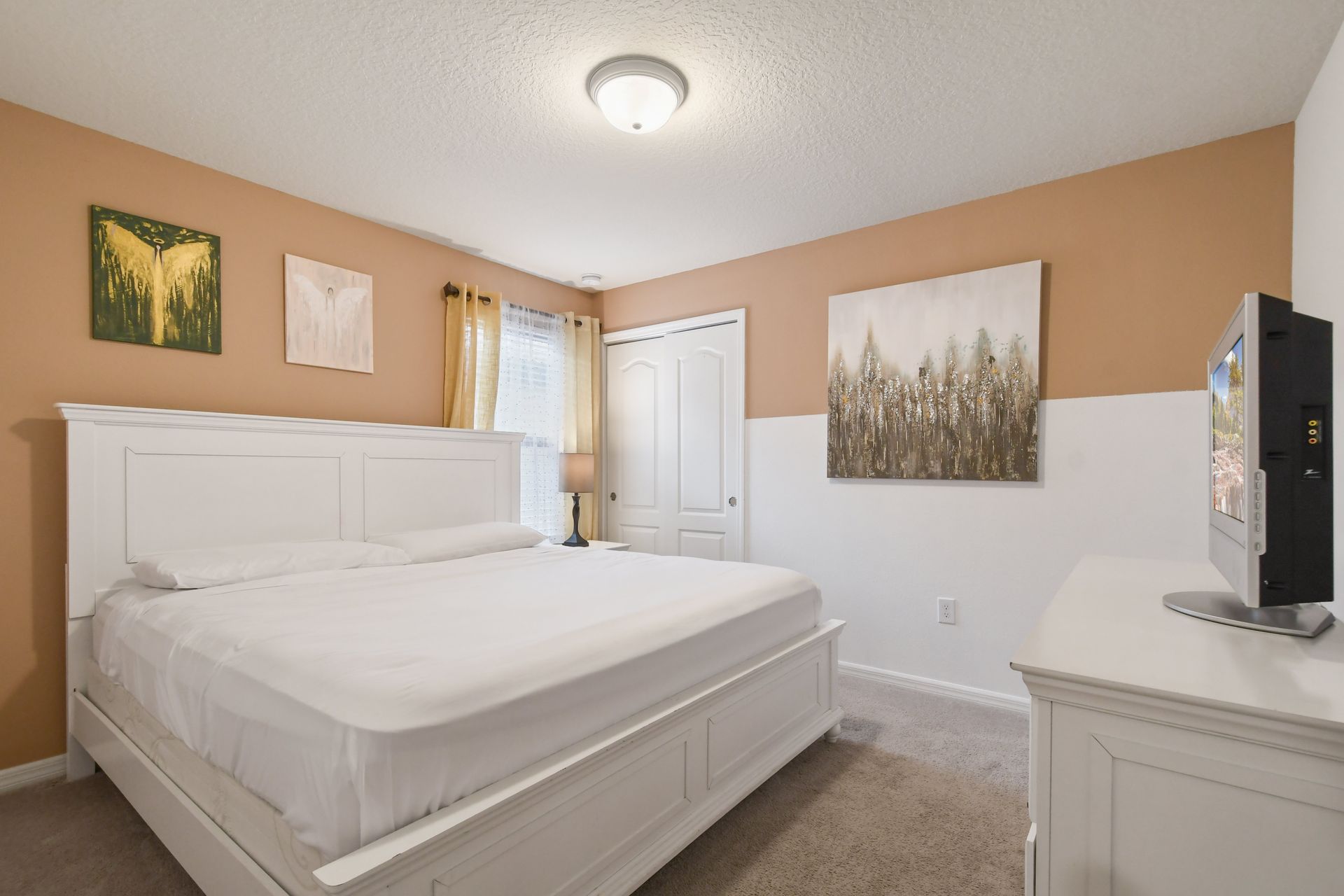 Warm and inviting bedroom with king bed, earthy tones, and cozy ambiance.