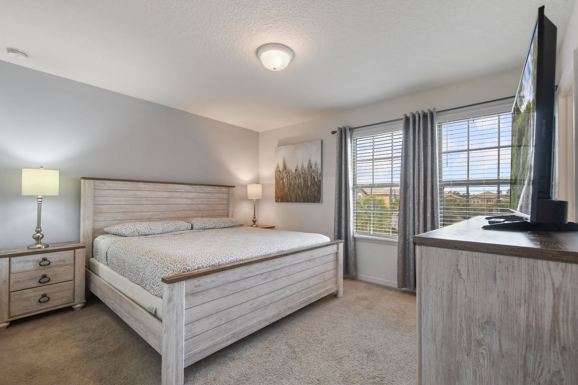 Serene bedroom with king bed, rustic charm, and plenty of natural light.