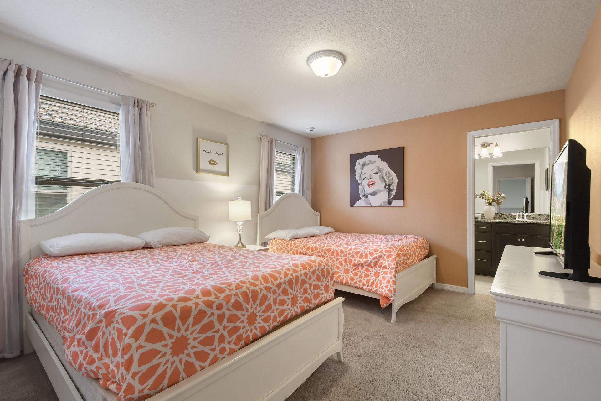 Bright and cheerful bedroom with two double beds, perfect for family stays.