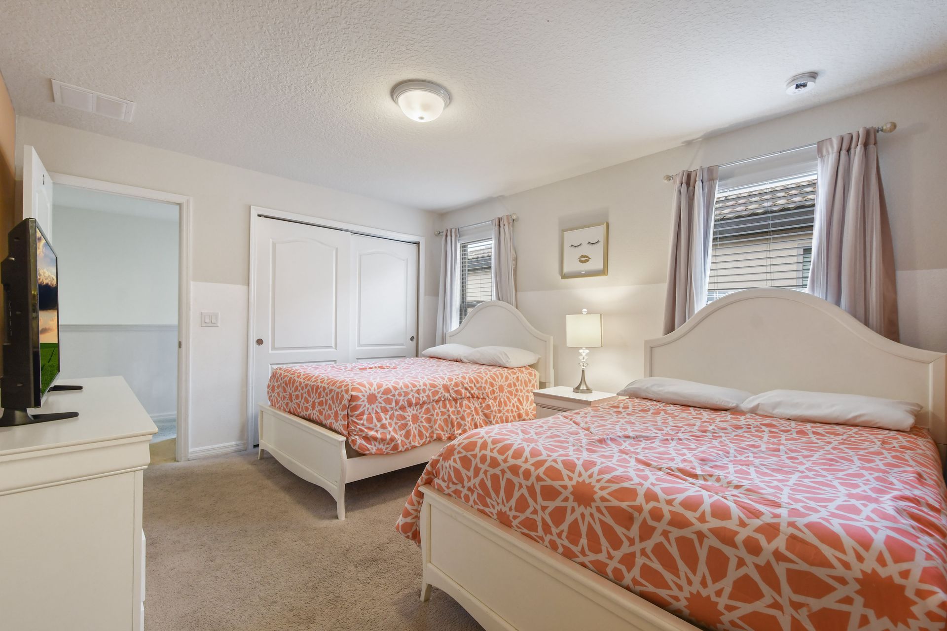 Bright and cheerful bedroom with two double beds, perfect for family stays.