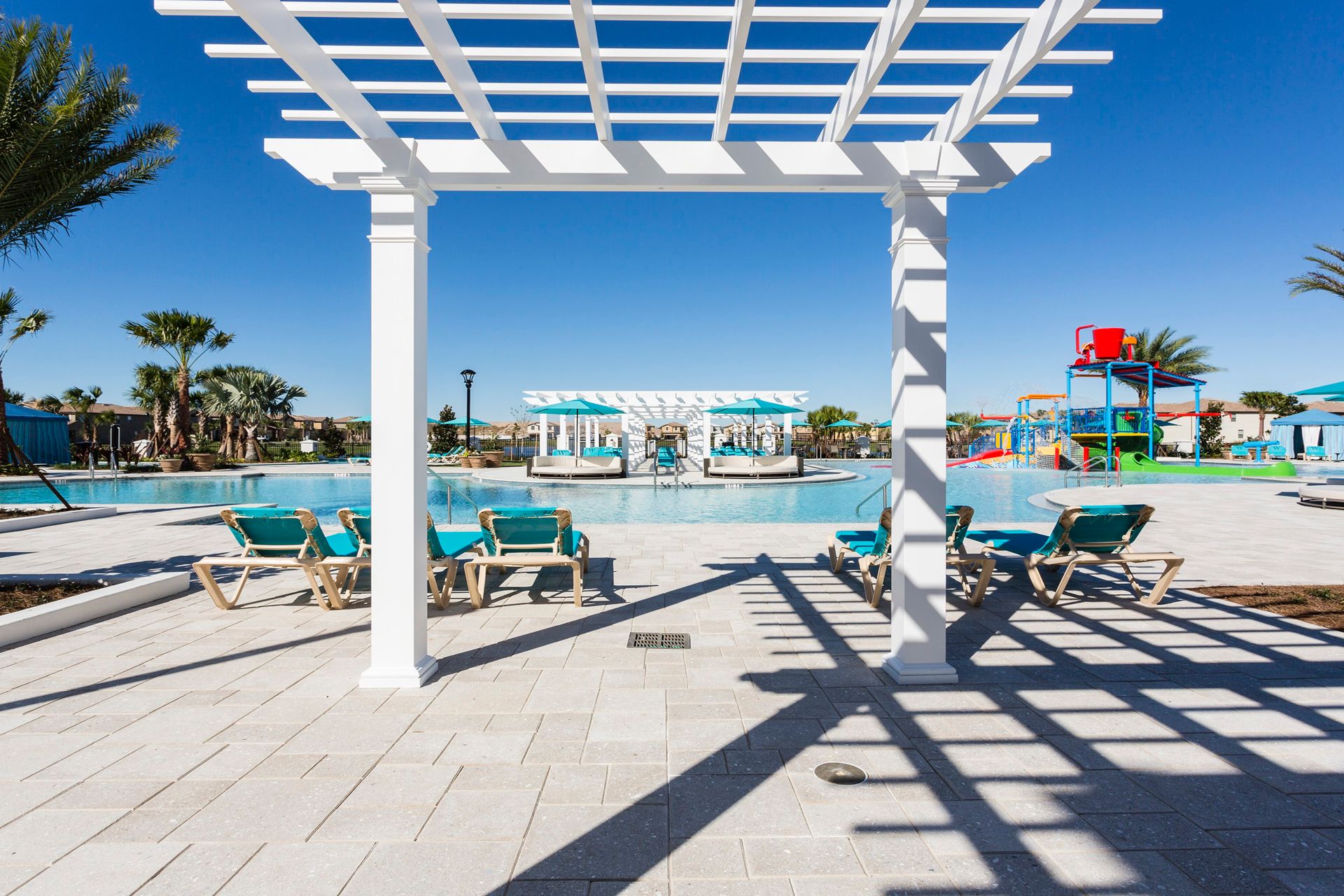 Relax by the pool under shaded pergolas with serene views.