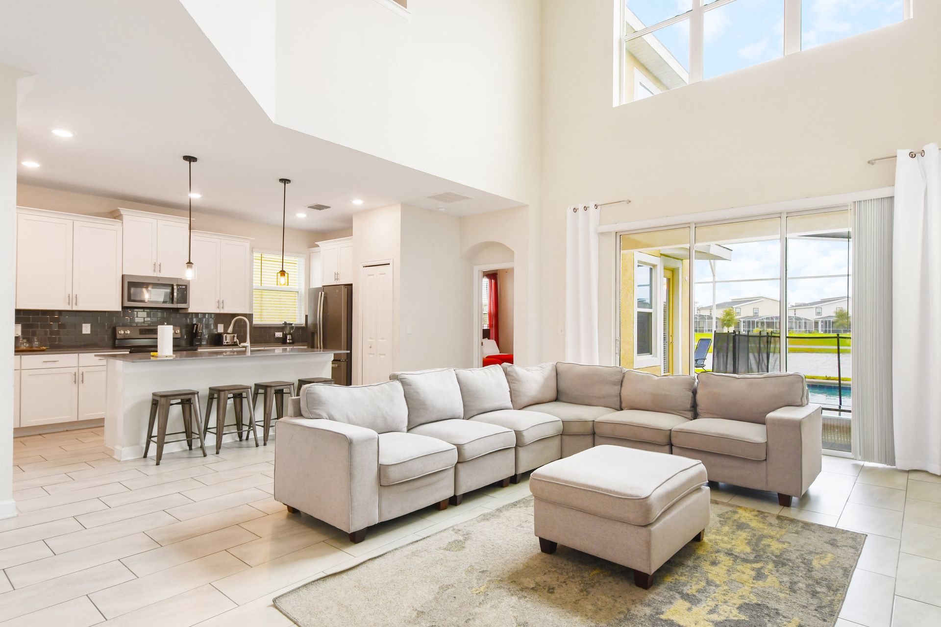 The spacious and elegantly designed living room serves as the heart of the home. It features a large, comfortable sofa.