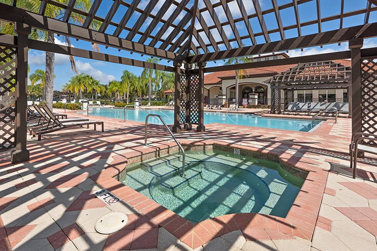 Relax in the shaded spa or lounge poolside in the Bella Vida resort.