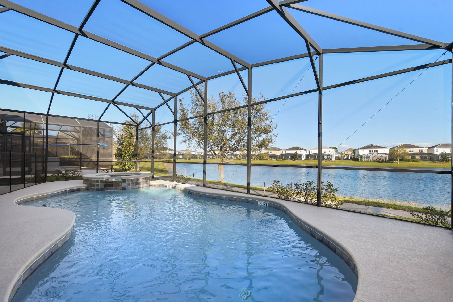 Relax by the private pool and spa with serene lakefront views