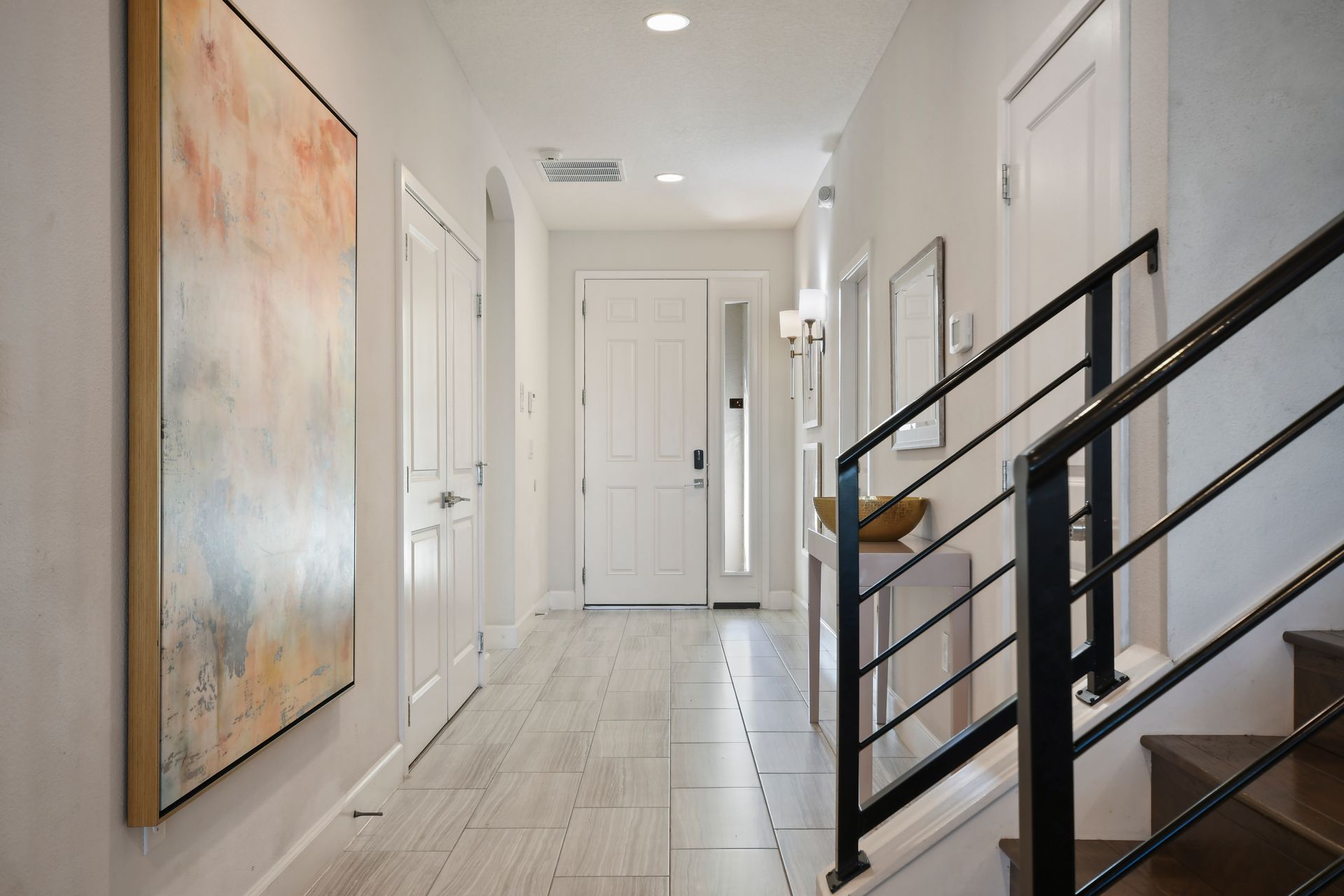 Bright entryway with modern decor and sleek staircase design