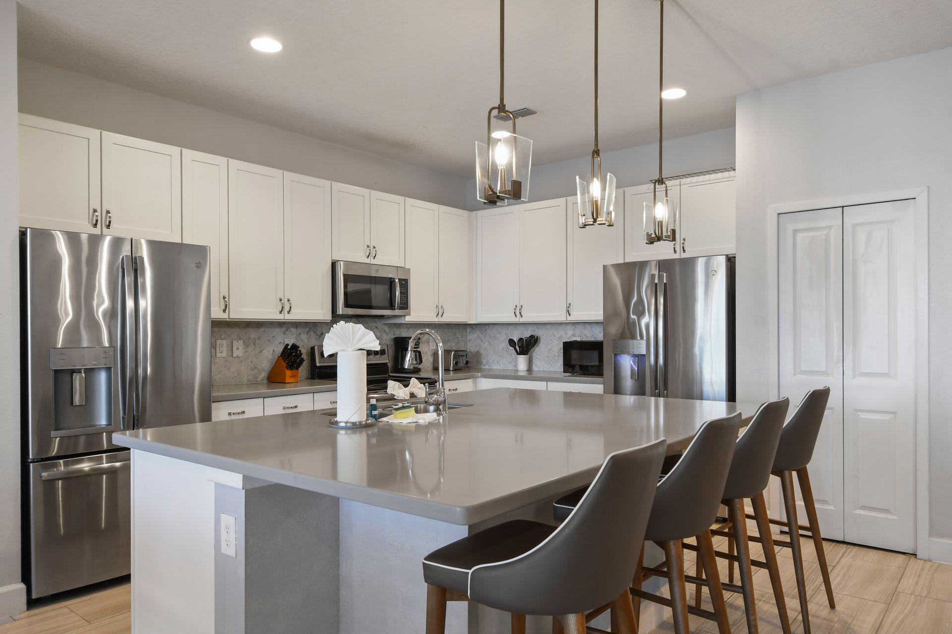 Sleek modern kitchen with stainless steel appliances and island seating
