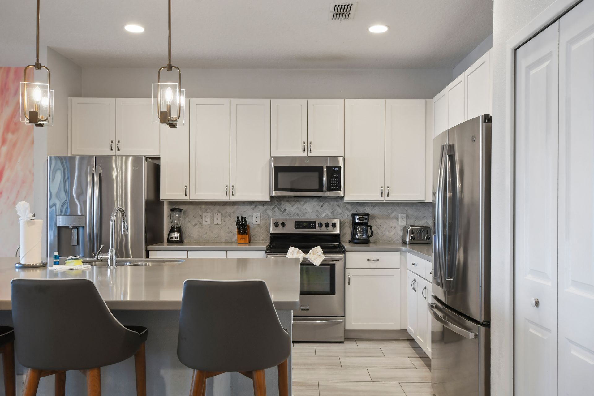 Bright, fully equipped kitchen with stainless steel appliances