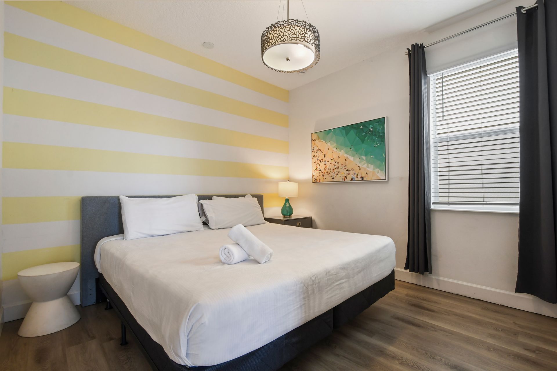 Bright bedroom with sunny yellow accents, cozy bedding, and modern decor