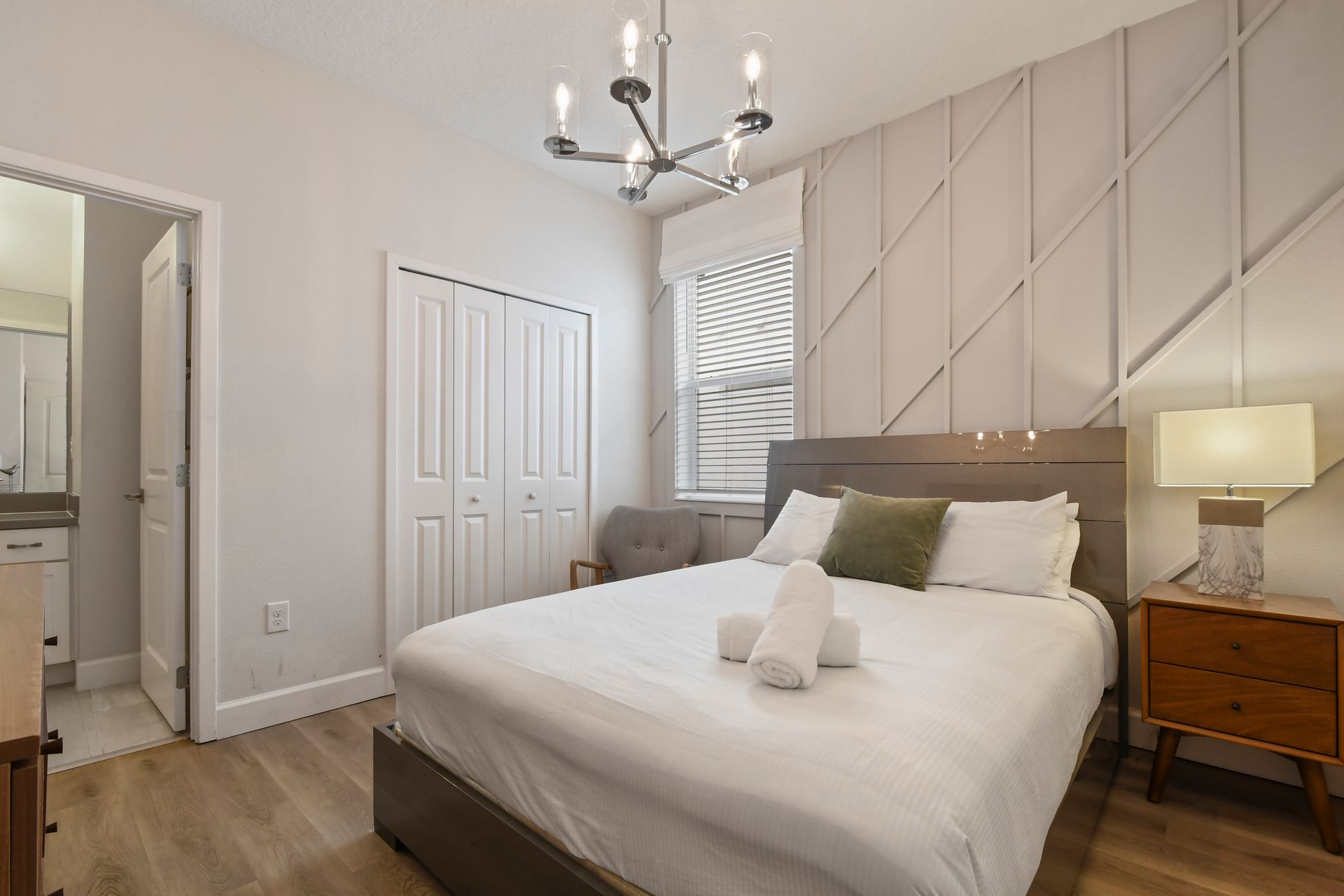 Cozy bedroom with modern design, soft lighting, and en-suite bath