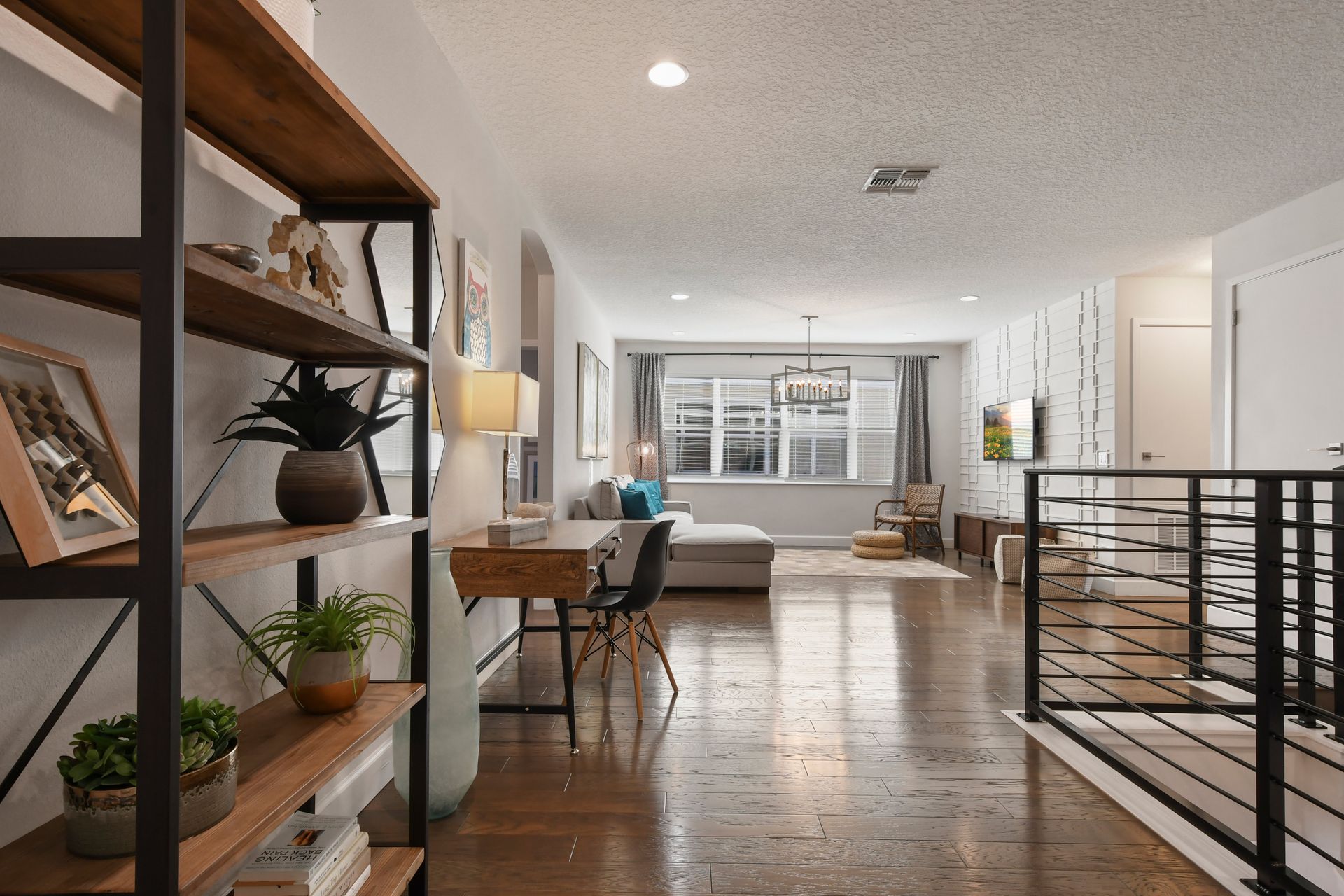 Spacious loft with a cozy lounge, chic decor, and a dedicated workspace