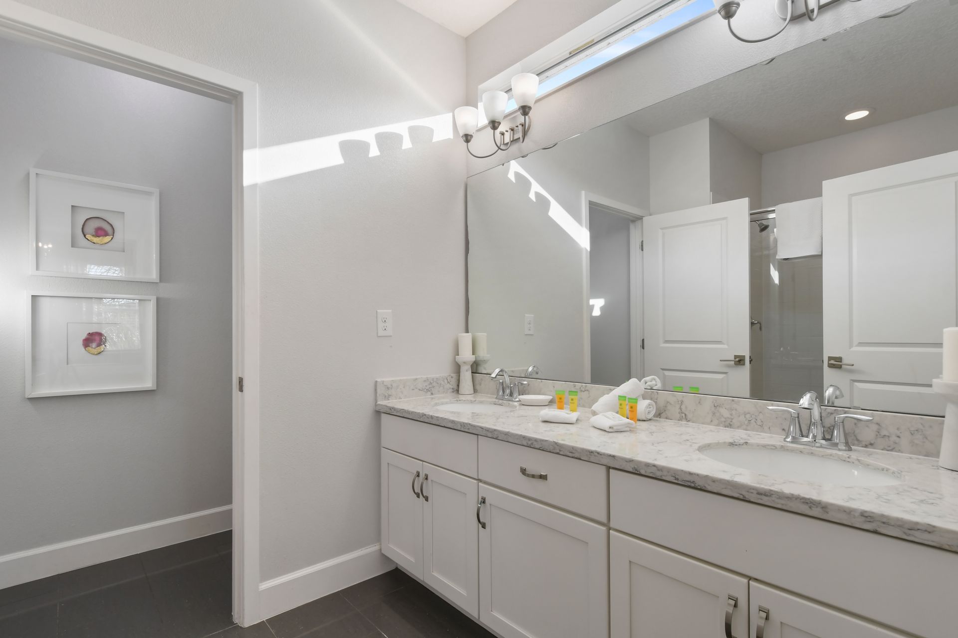 Modern bathroom with sleek shower, spacious vanity, and amenities