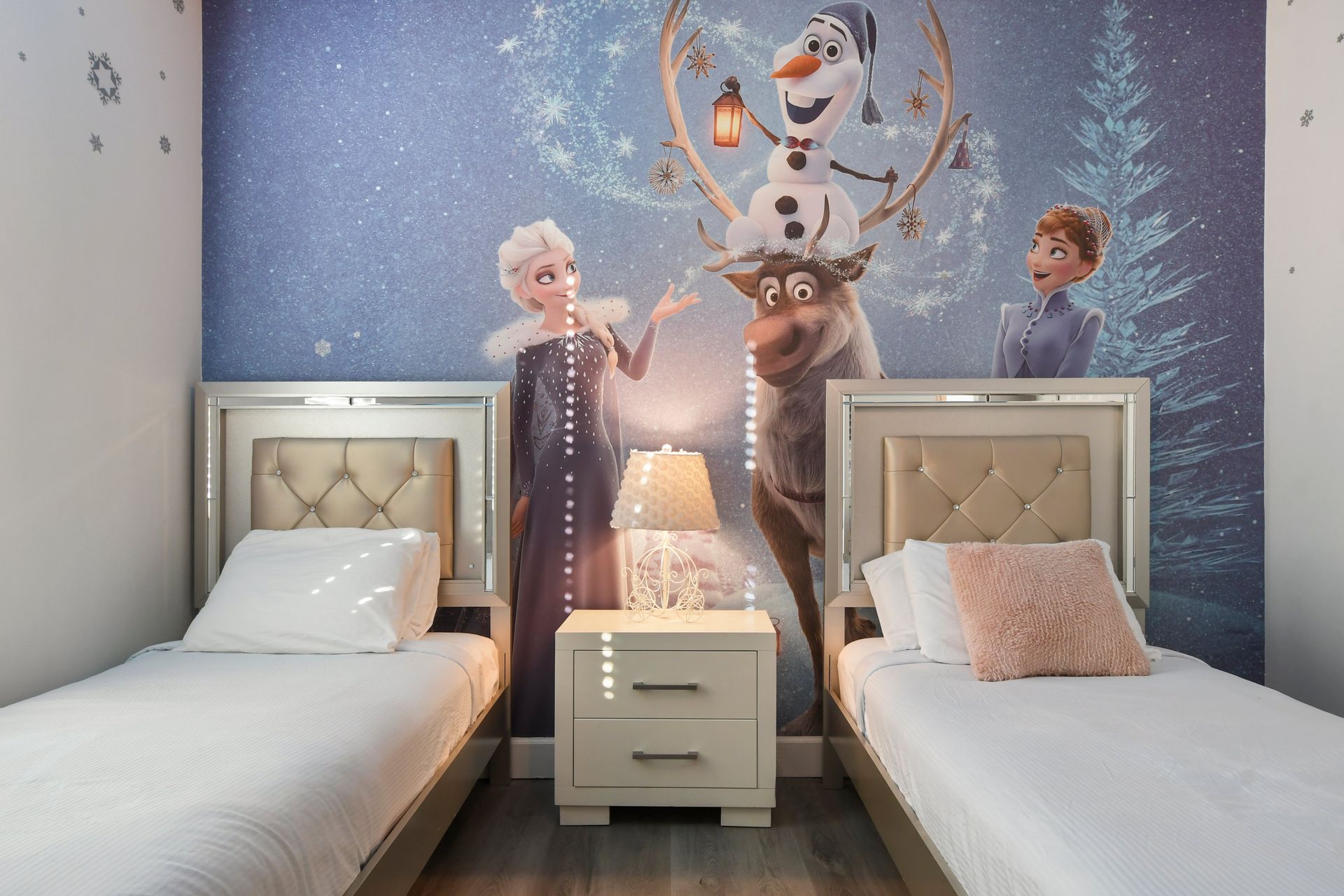 Frozen-themed bedroom with shimmering twin beds and magical decor