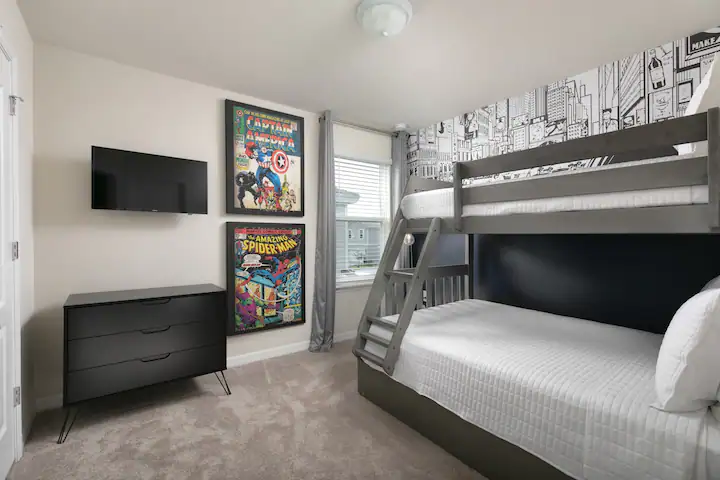 Superhero-themed bunk room with TV, perfect for kids and comic book lovers.