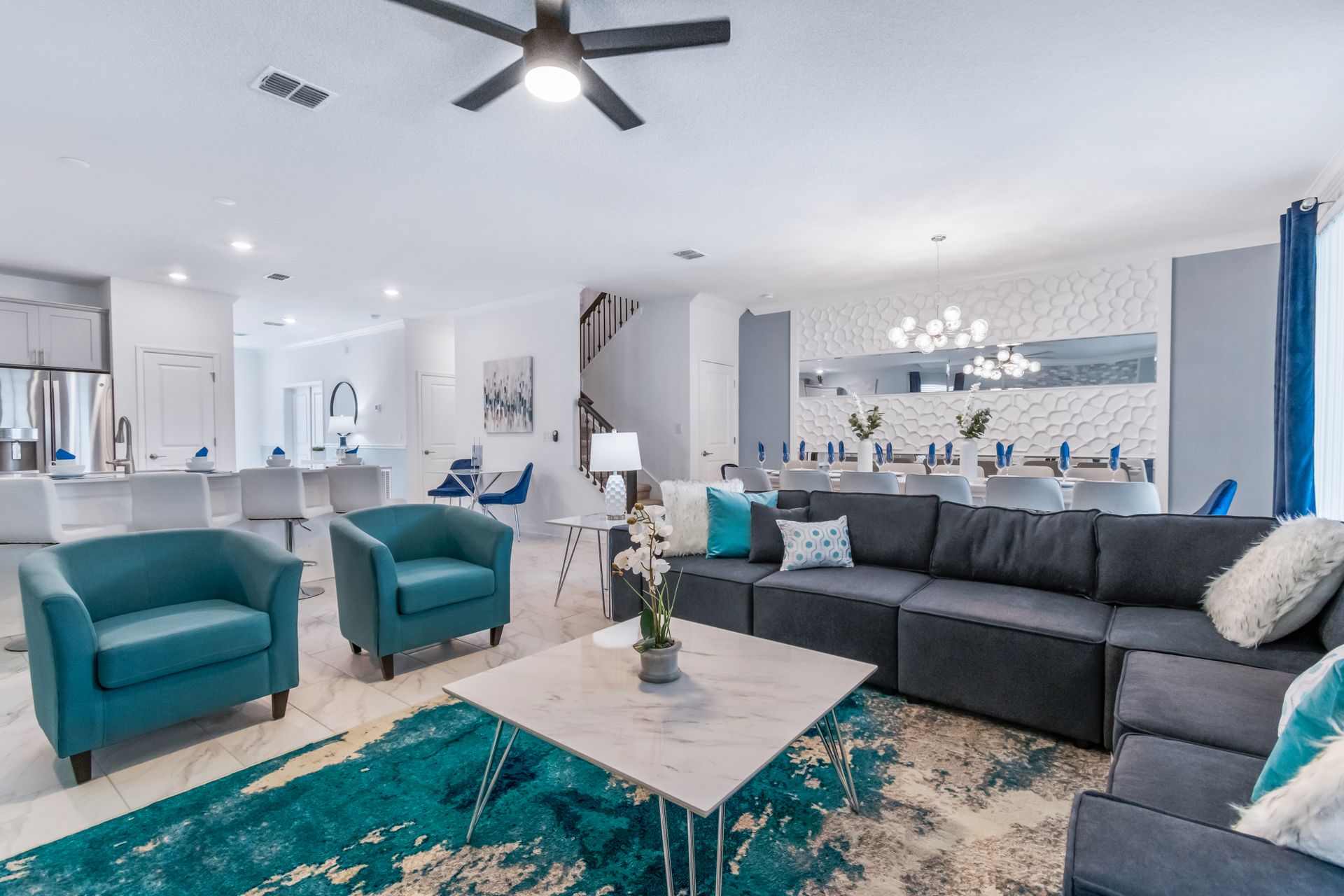 Spacious open living area with modern kitchen, elegant dining, and cozy seating
