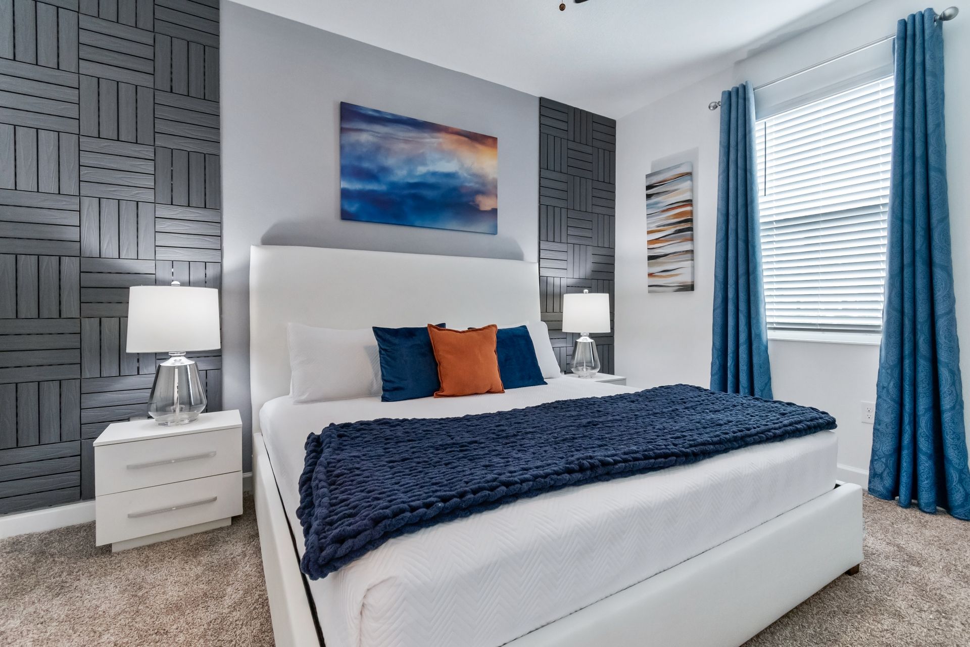 Modern master bedroom with plush king bed, bold accent wall, and cozy decor
