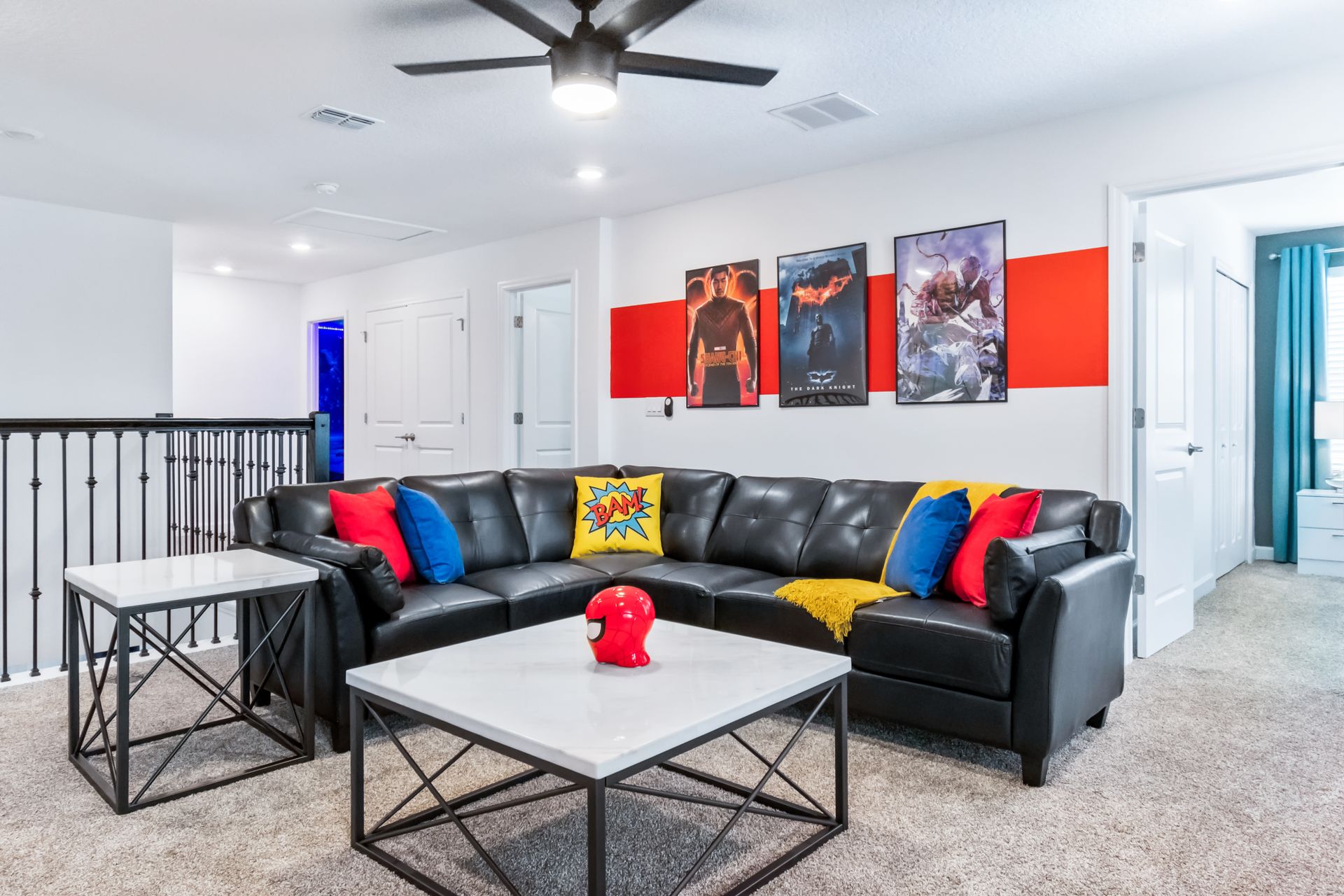 Superhero-themed loft with comfy leather sofa, big TV, colorful pillows, and decor
