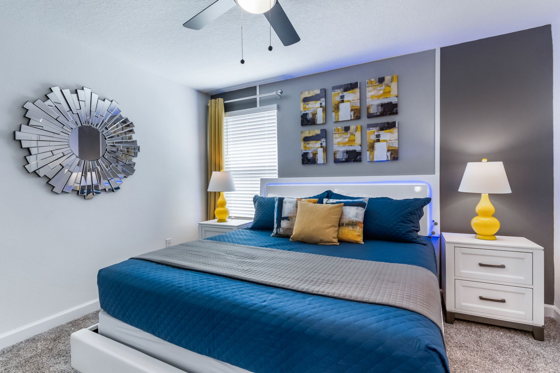 Colorful modern bedroom with king bed, stylish art, bold accents, and cozy vibe
