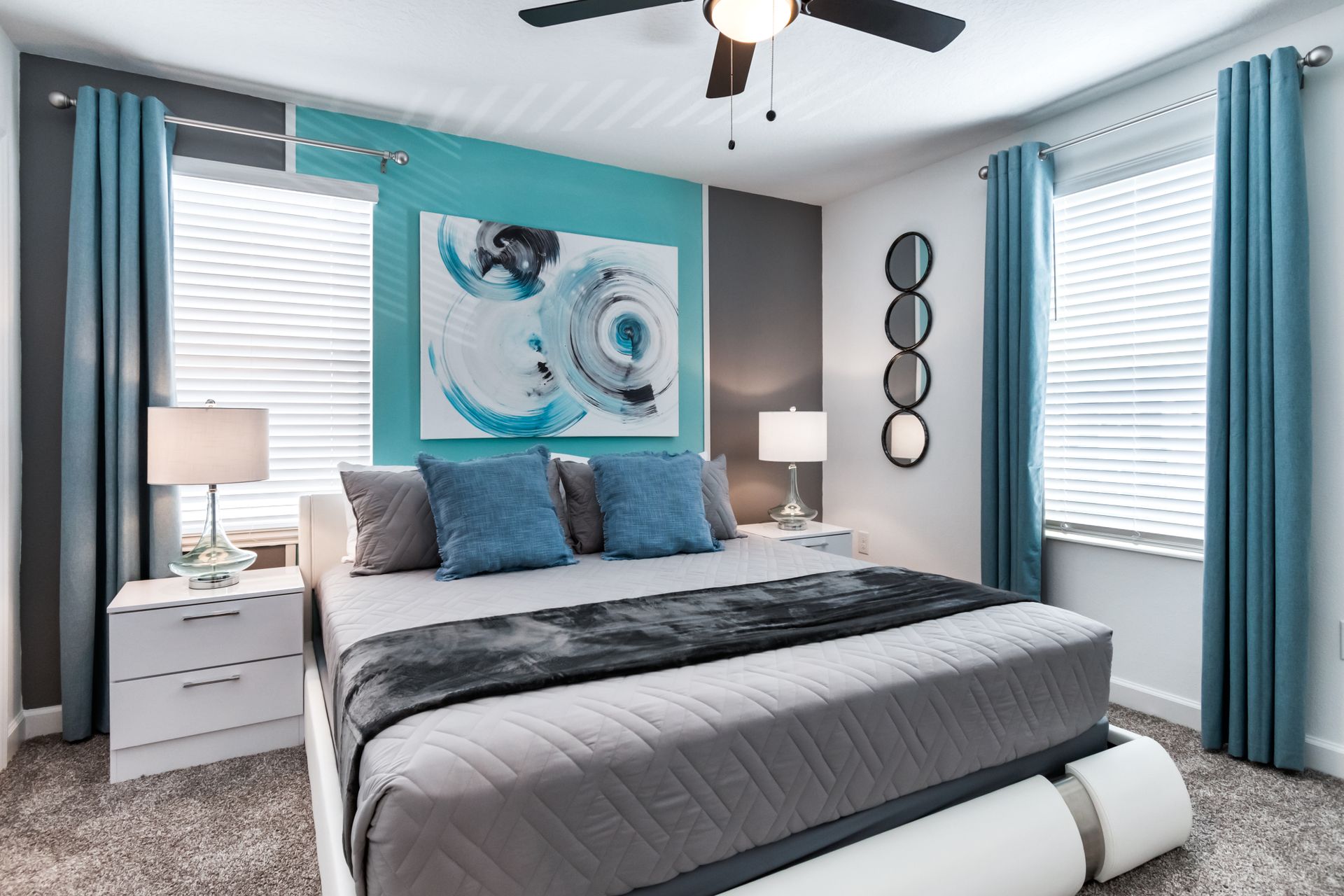 Modern tranquil bedroom with king bed, blue accents, chic art, and cozy atmosphere
