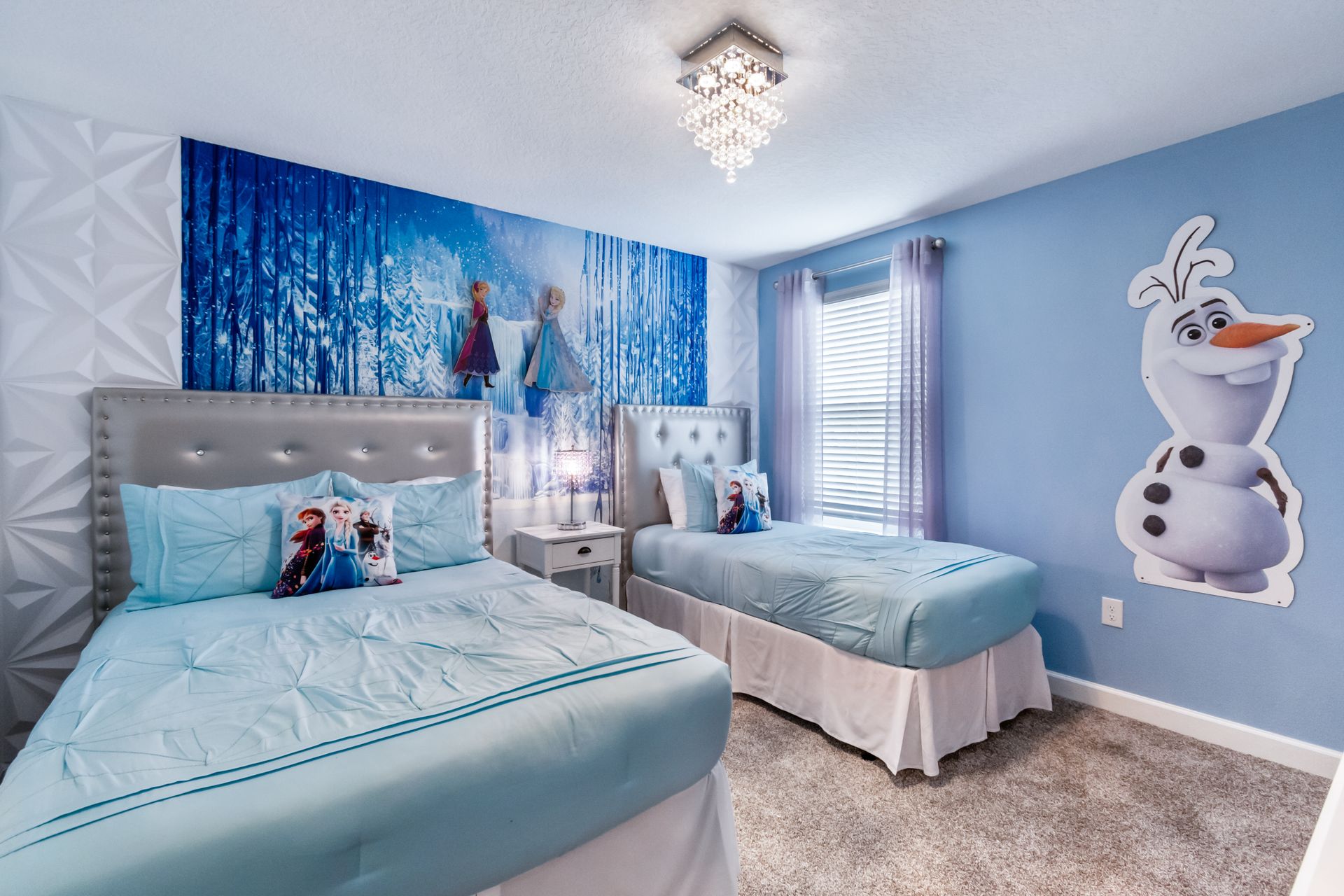 Magical Frozen-themed kids room with mural, Olaf decor, cozy beds, and sparkle
