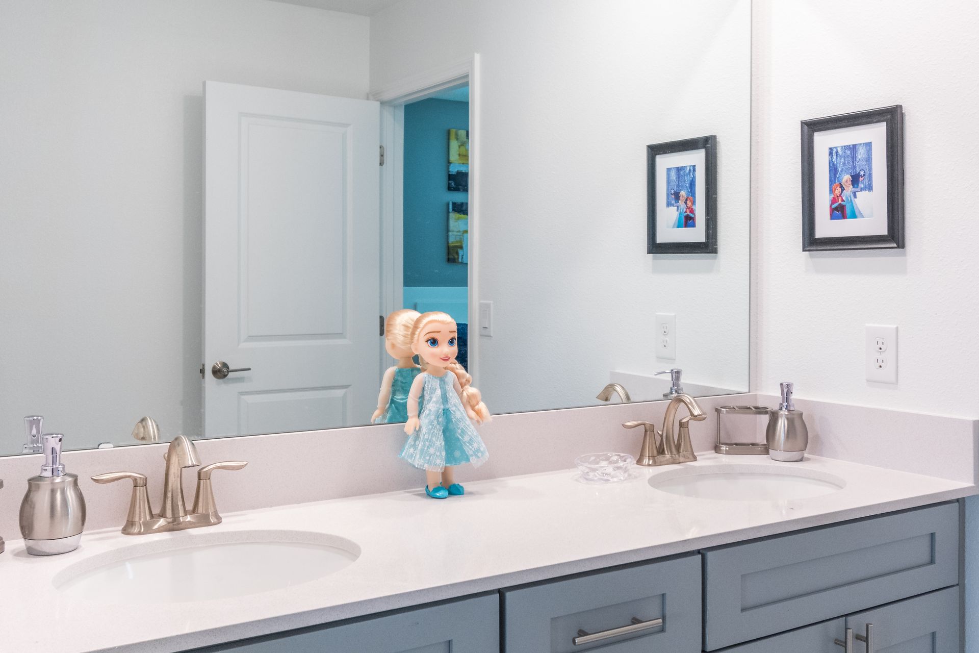 Charming kids bathroom with Frozen decor, double sinks, and playful icy accents
