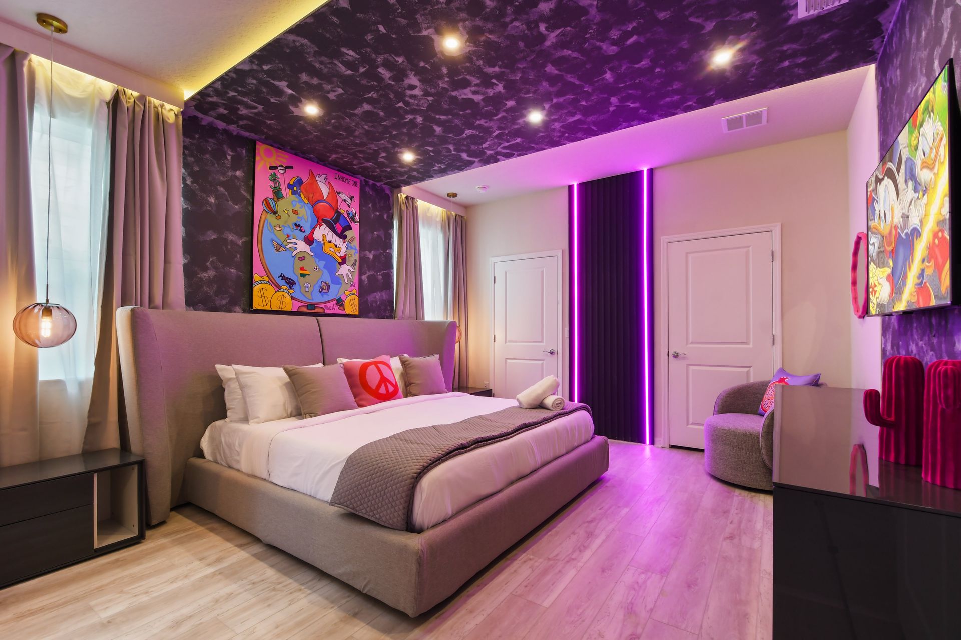 Trendy bedroom with modern decor, neon accents, and vibrant wall art.