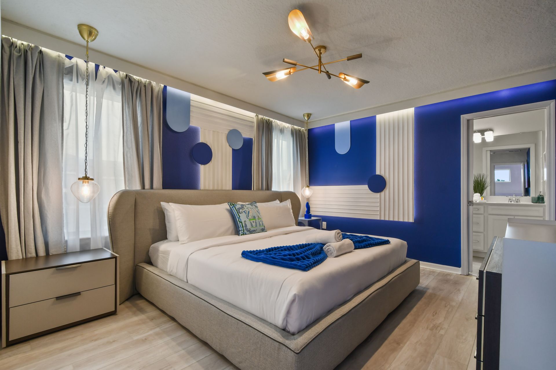 Modern room with bold blue accents, cozy lighting, and stylish décor.