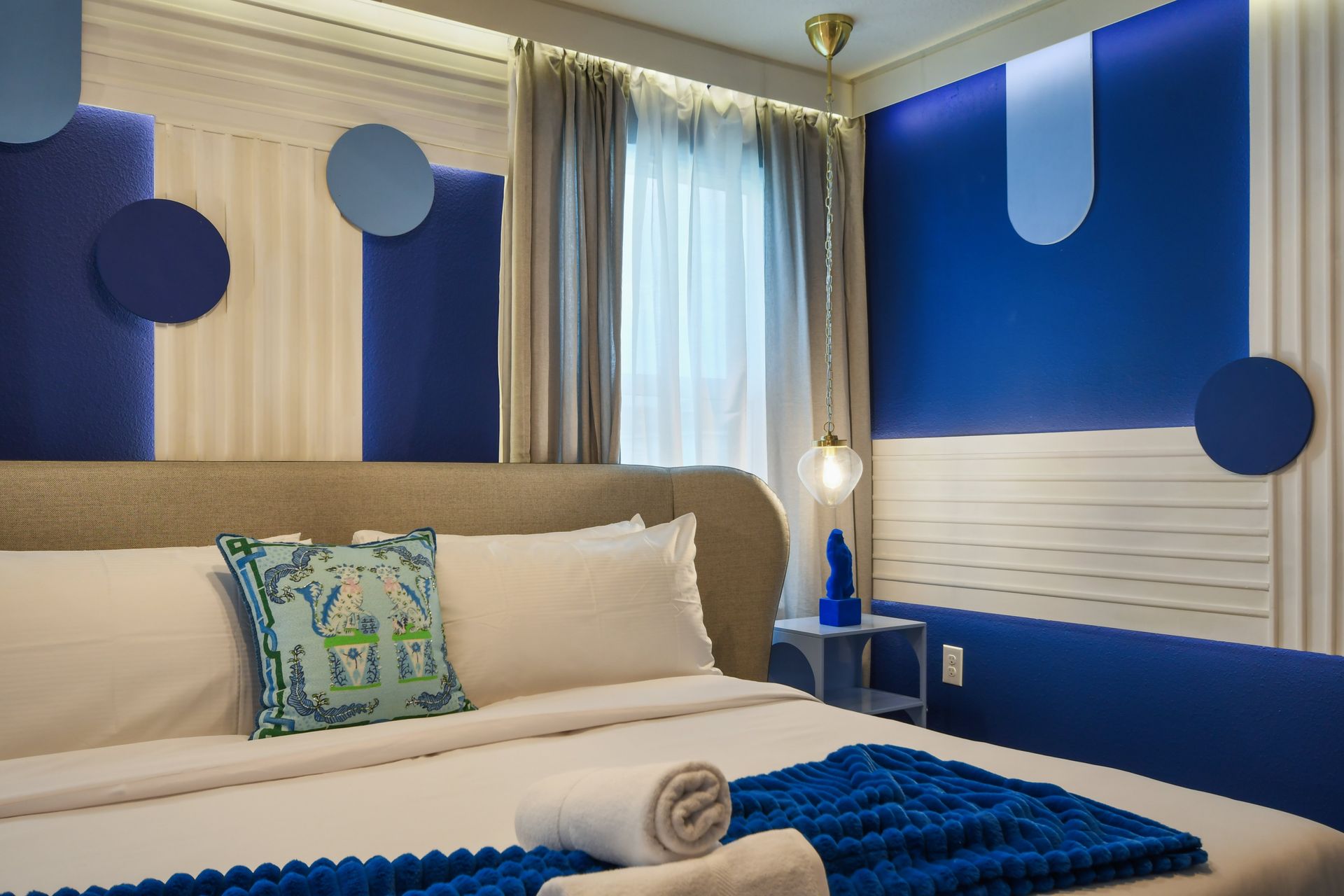 Stylish bedroom with bold blue accents and contemporary design details.