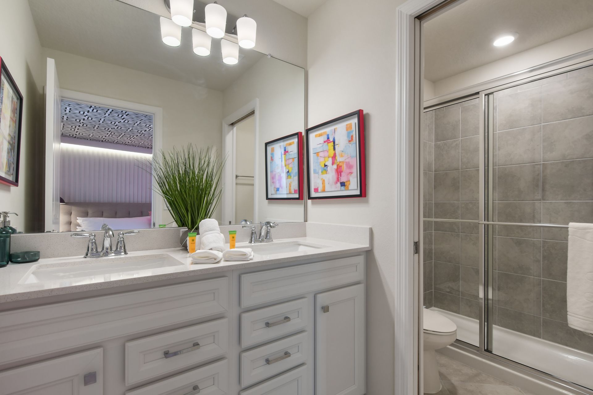 Elegant bathroom with double sinks, modern decor, and a spacious shower.