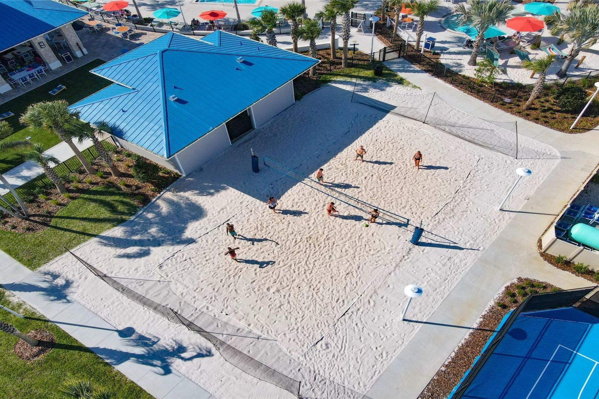 Spacious sand volleyball court surrounded by resort amenities for active fun in the sun.
